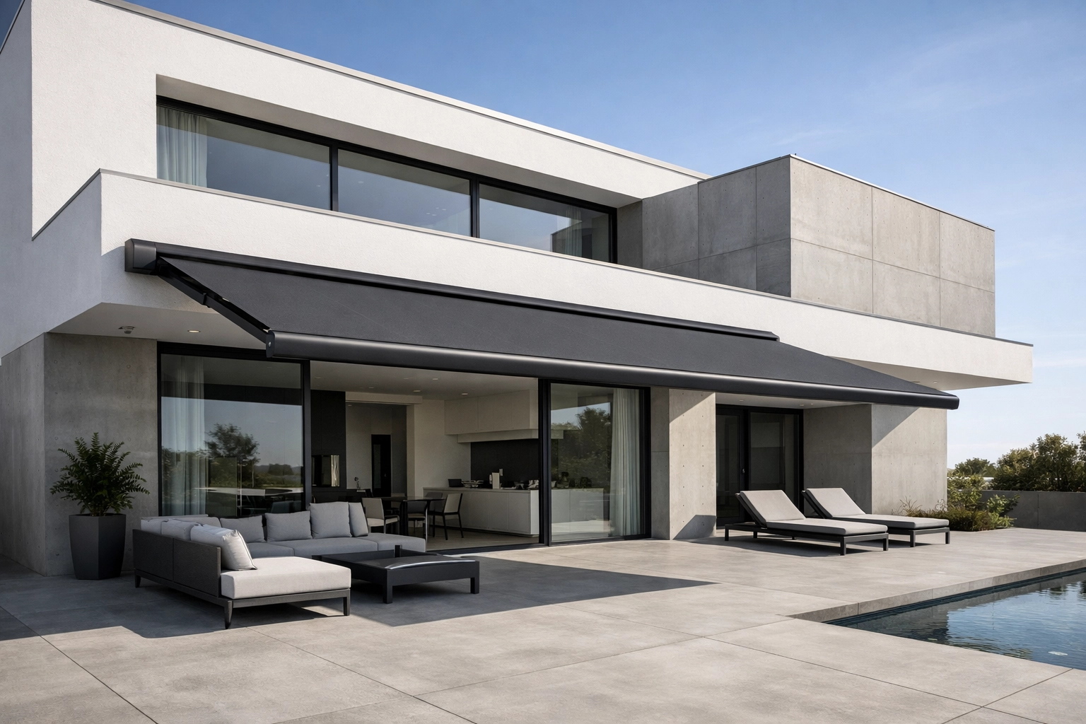 Moderne Villa mit einer anthrazitfarbenen Markise nach Maß und Vollkassette über der Terrasse.