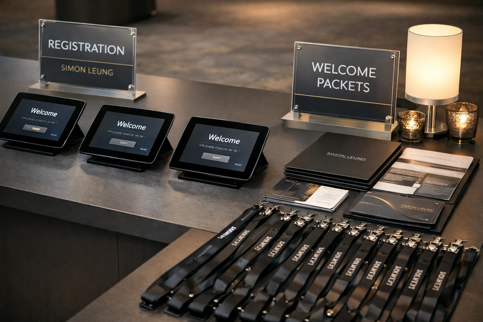 Professional event registration and check-in desk setup with tablets and welcome materials
