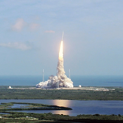 A rocket launches into the sky from Kennedy Space Center Cruise Cocoa guests experience live rocket launches like this from the water, offering unobstructed views and educational commentary from our captains aboard our sightseeing boats.