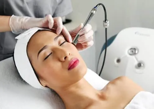 A client is receiving a professional microdermabrasion facial at BodyBrite Cooper City to exfoliate and rejuvenate.