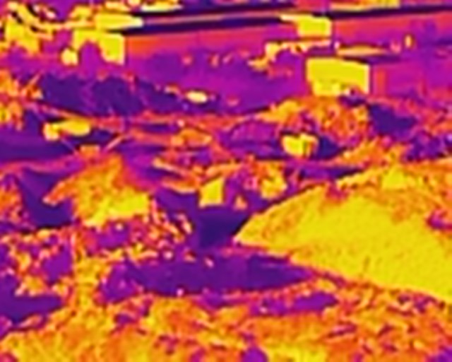 Thermal drone image showing temperature variations over a mixed-use site
