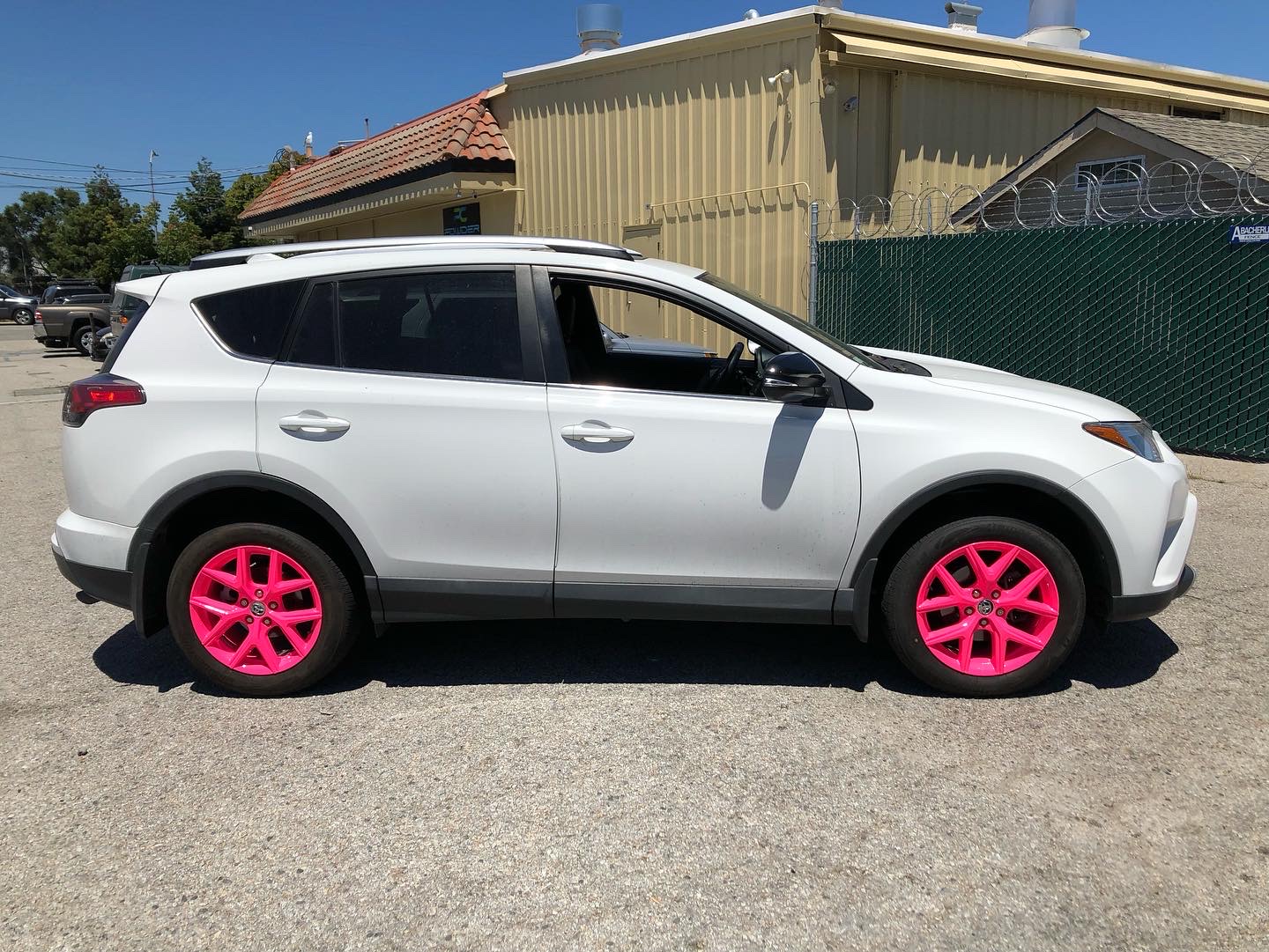 White SUV with Neon Pink Powder Coated Rims