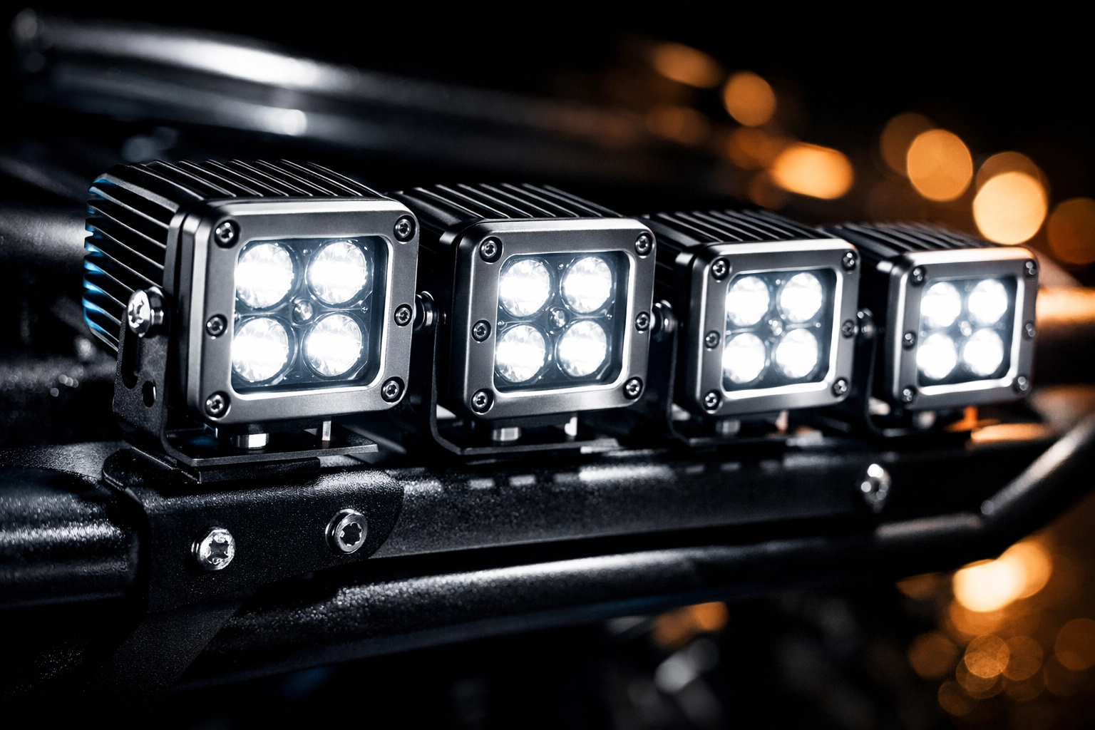 Compact LED cube lights mounted on aluminum bumper bracket showing heat sink cooling fins