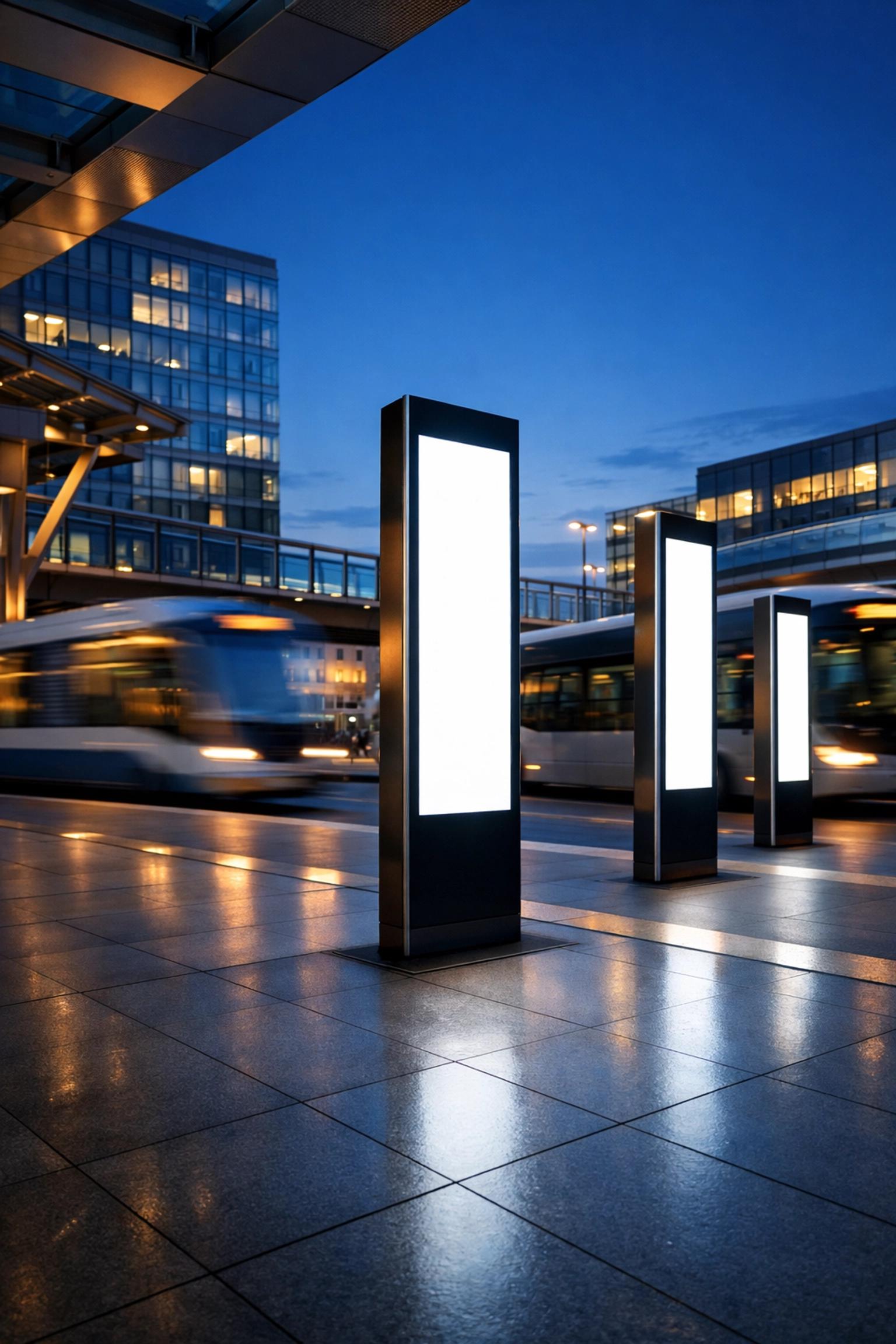 Smart city transportation hub featuring illuminated digital signage pylons for urban transit infrastructure.