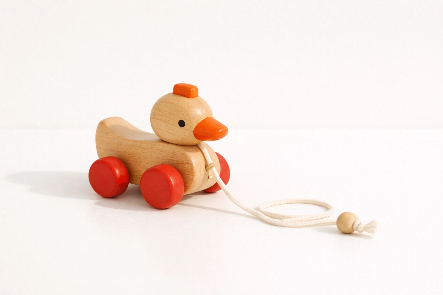Single small classic toy on a clean white background symbolizing childhood and possibility