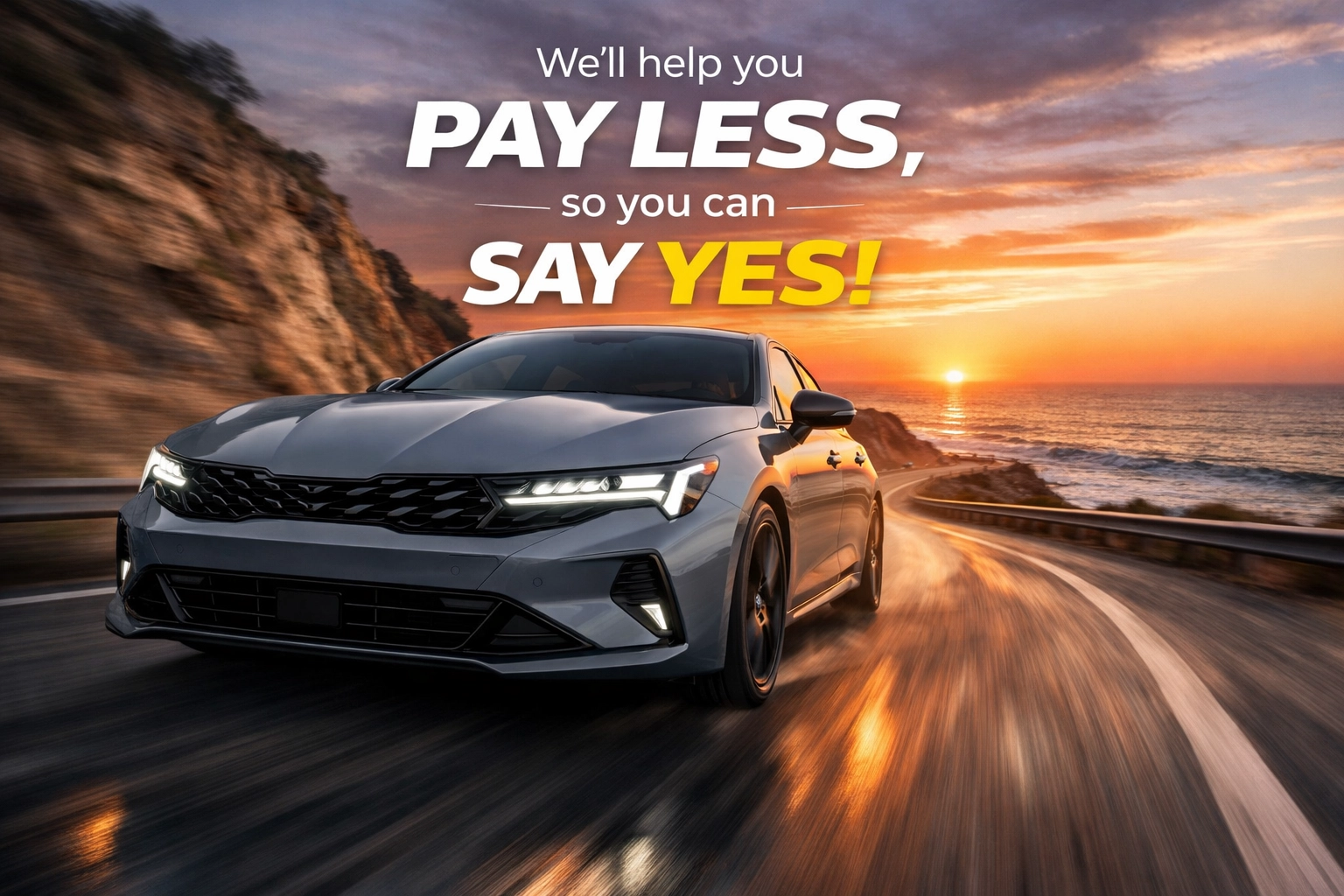 2026 Kia K5 sports sedan in Wolf Gray cruising along a beautiful coastal road at sunset.