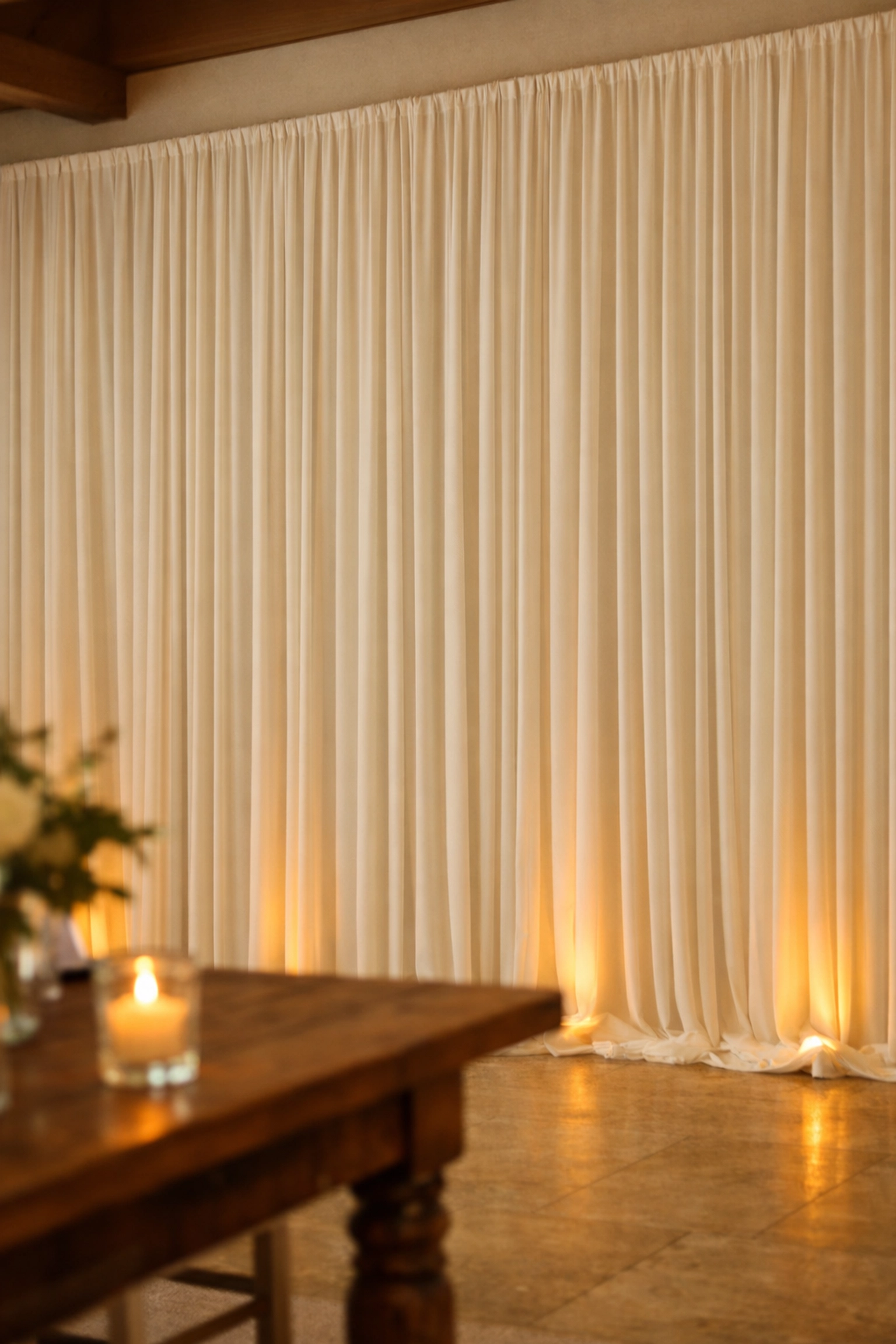 Ivory pipe and drape rental in a Fort Wayne venue for a refined rehearsal dinner setup by The Weathered Moose LLC.