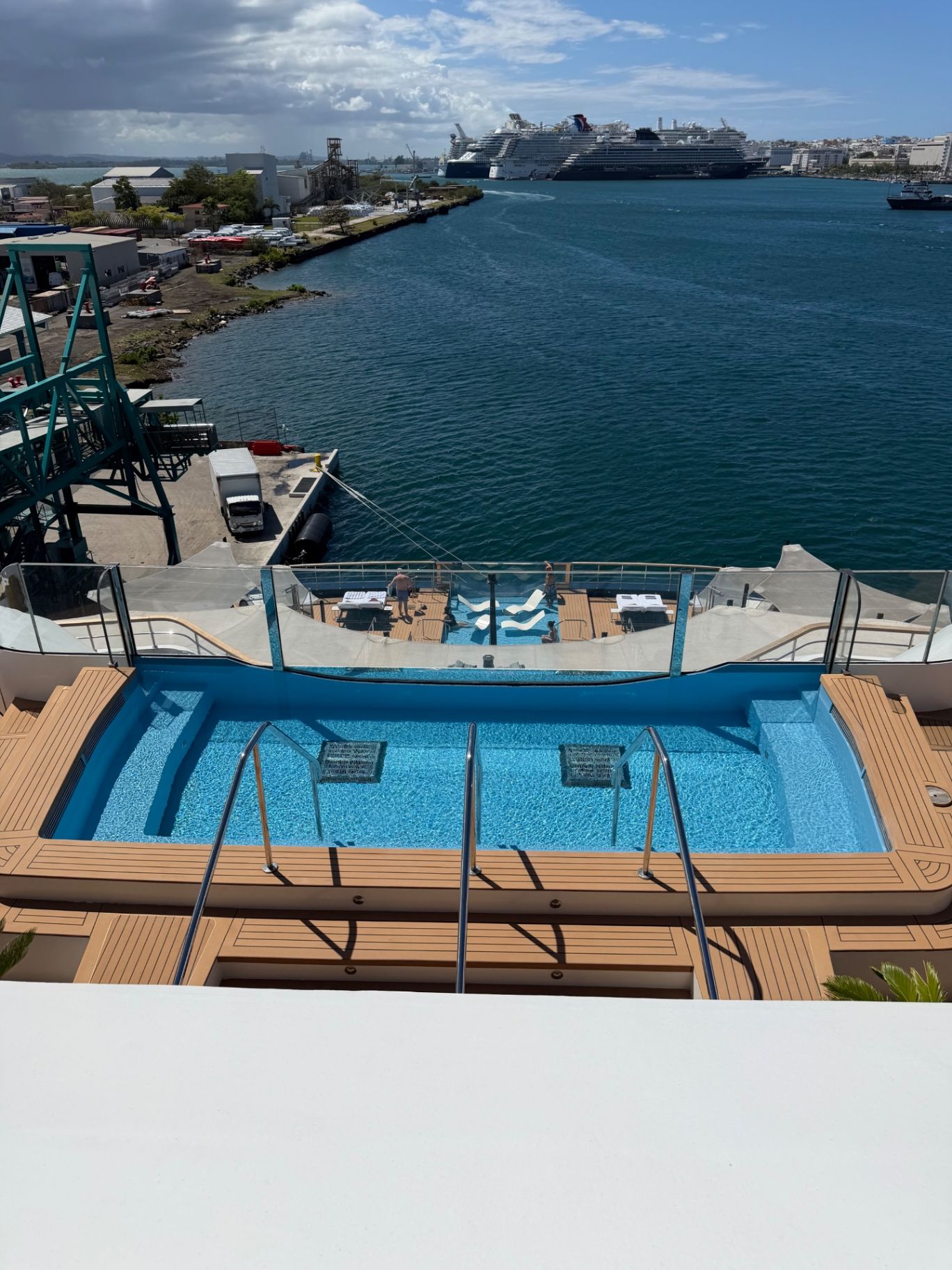 a pool on a deck overlooking a body of water