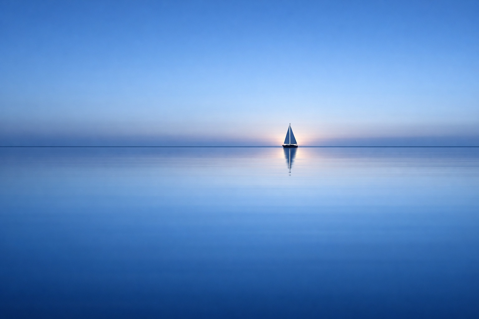 A sailboat on Mobile Bay at dusk, symbolizing the new horizons and freedom after selling an Alabama company.