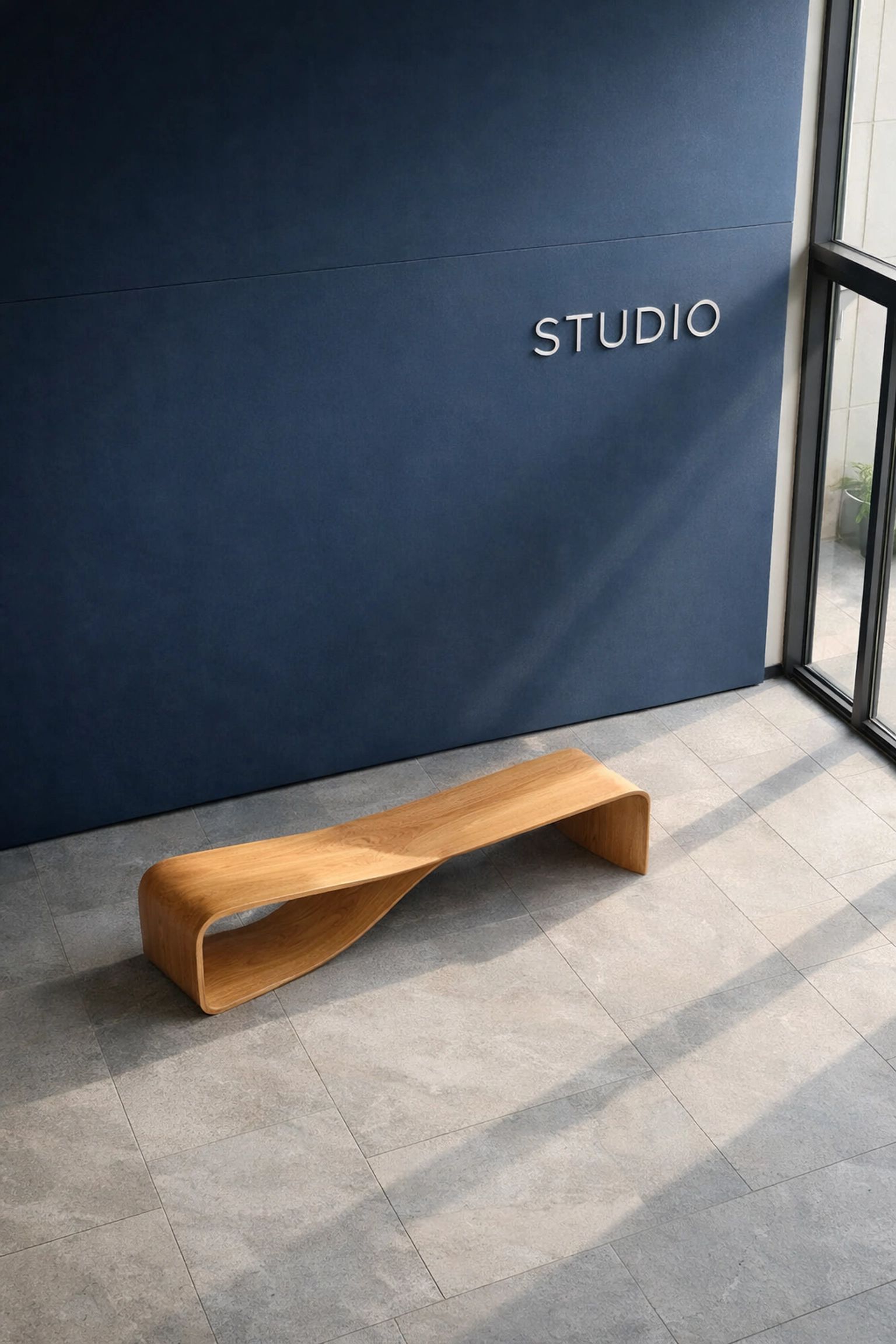 Modern minimalist studio entrance with a navy wall and wood bench representing bold web design for local brands.