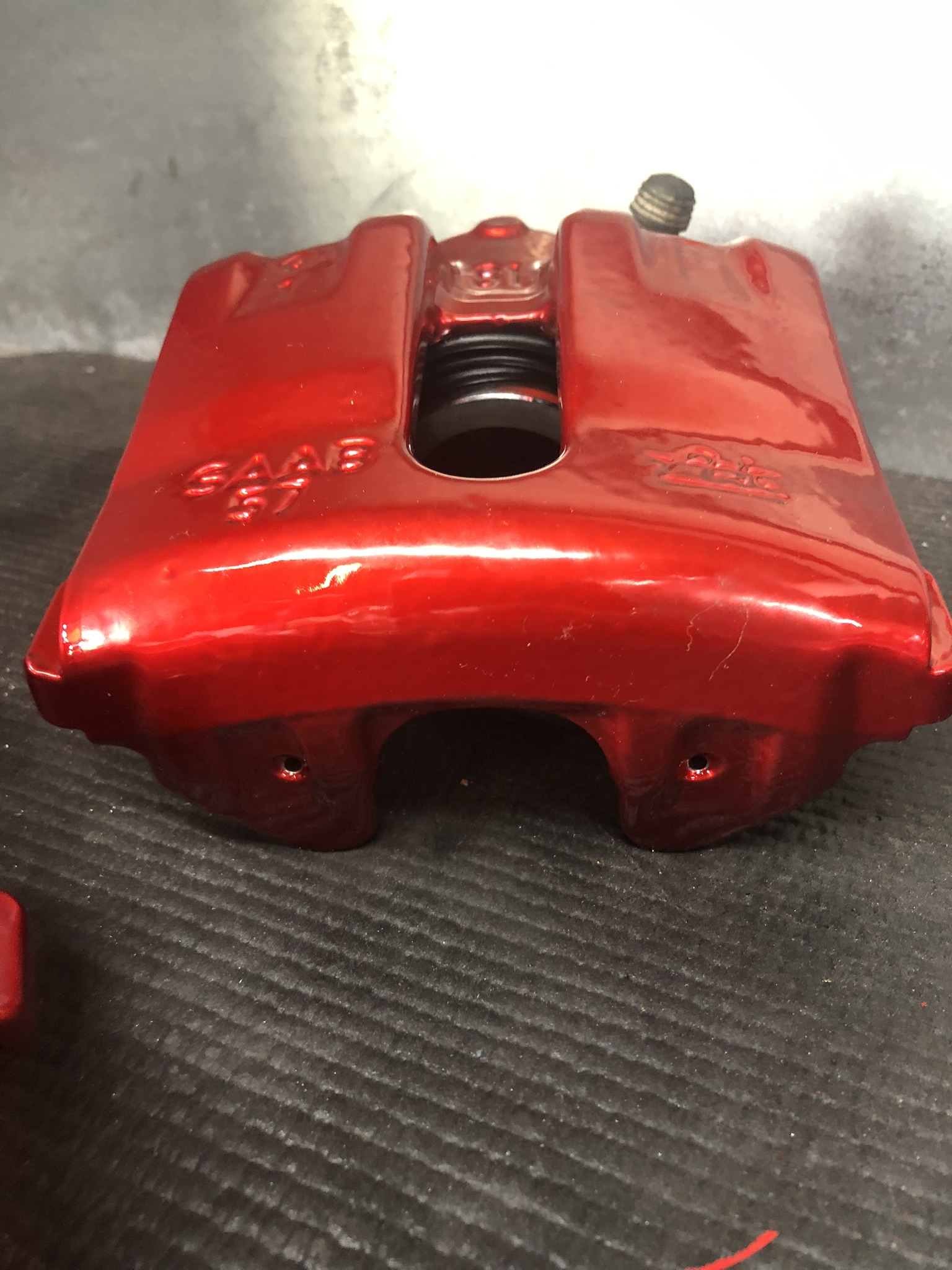 Metallic red SAAB brake caliper powder coated with a crisp logo for a factory-plus finish.