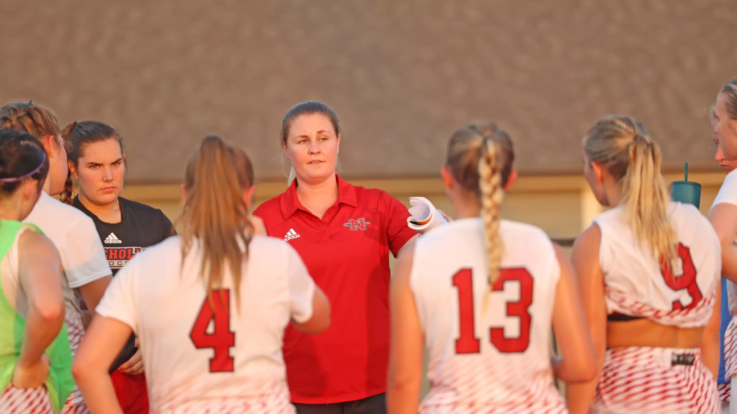Female College Soccer Coach Giving Instructions