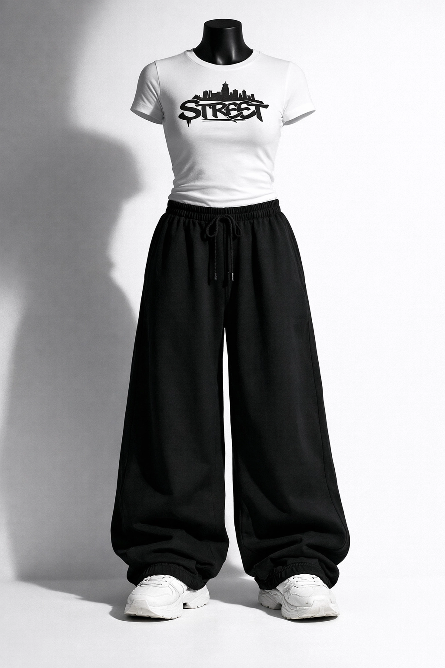 PWPTAOS wide-leg black pants styled with fitted white graphic t-shirt and chunky white sneakers