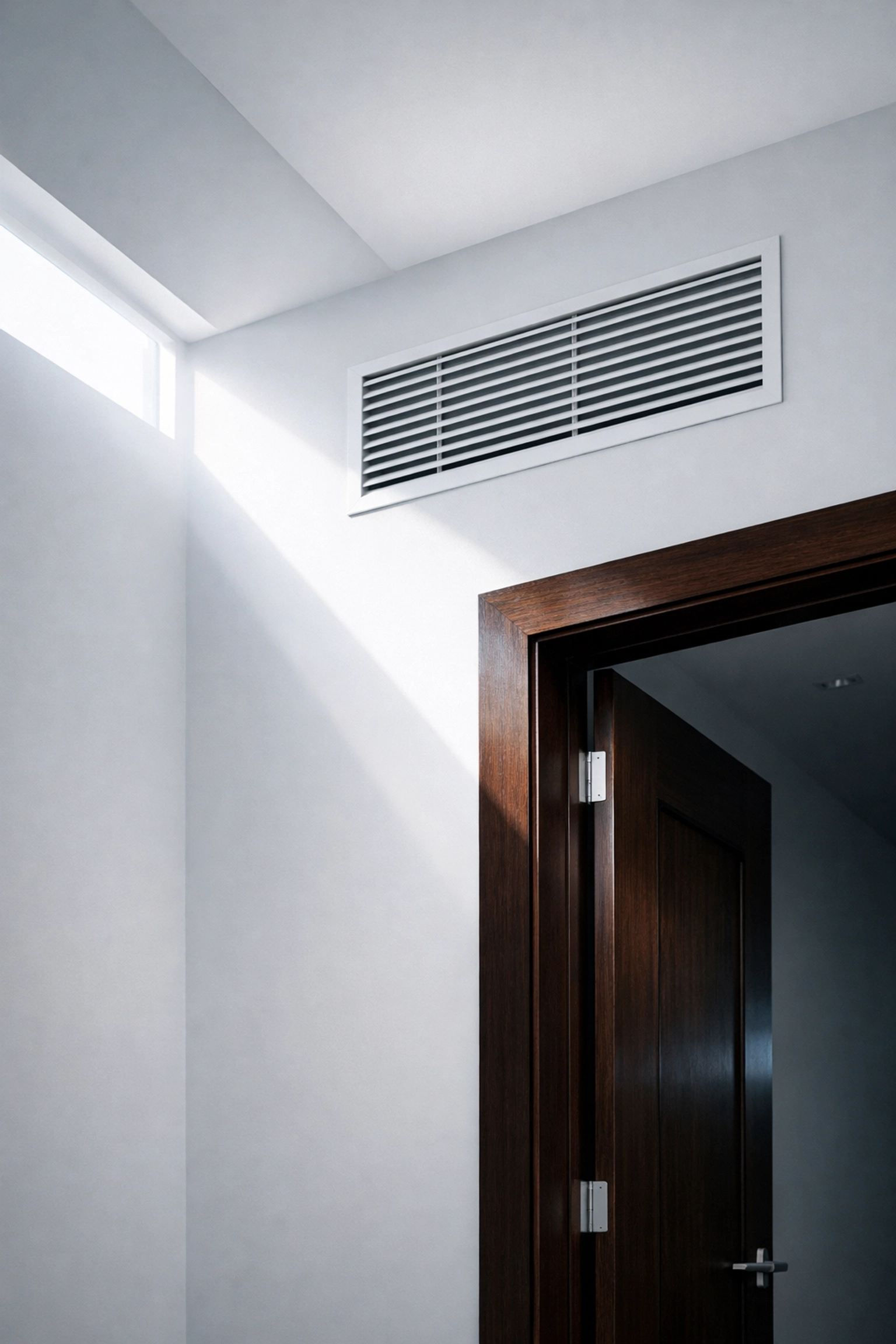 Sunlit hallway with clean air vents after professional post construction cleaning for a dust-free home.