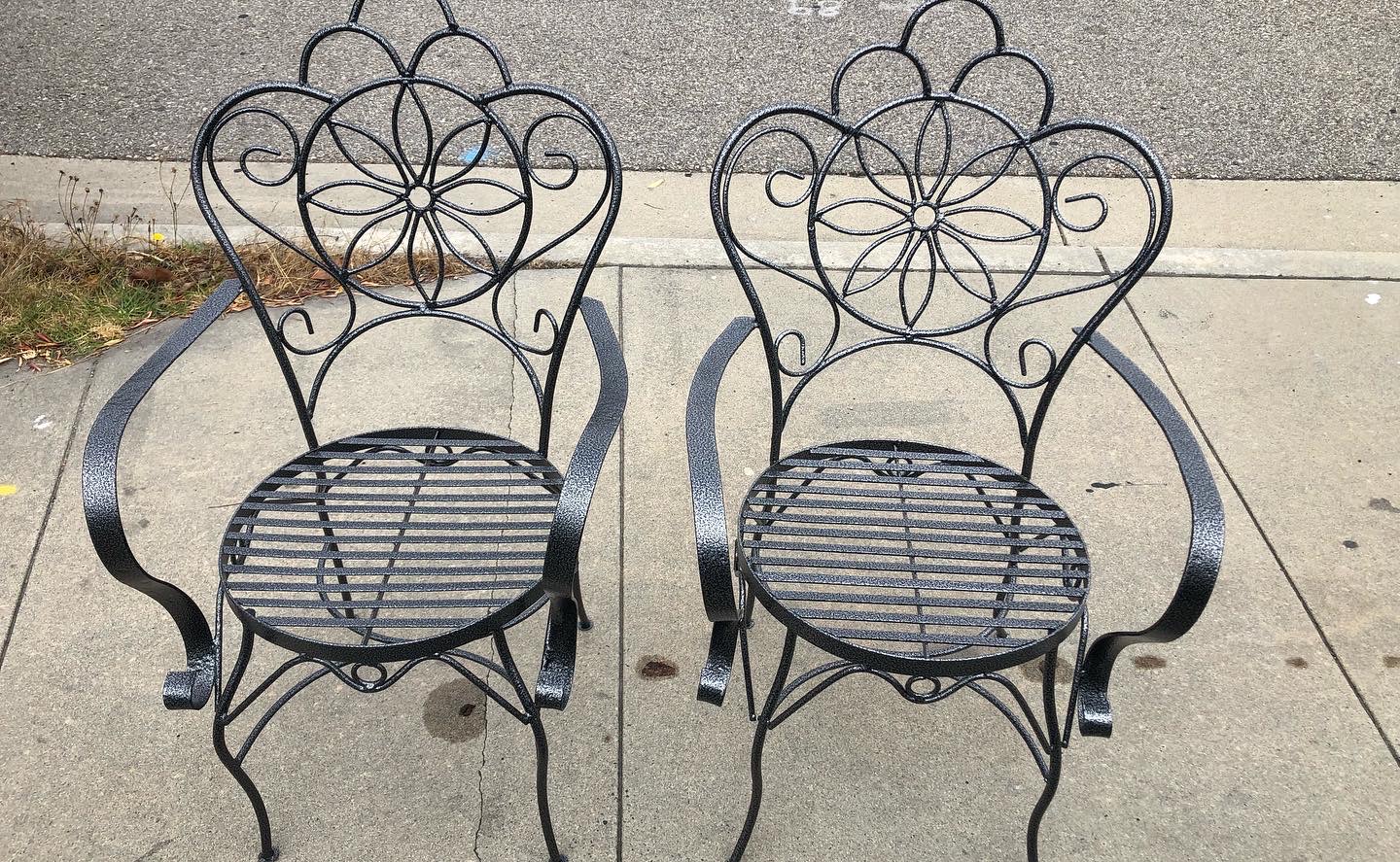 Black powder-coated patio chairs restored with a durable finish after sandblasting and coating