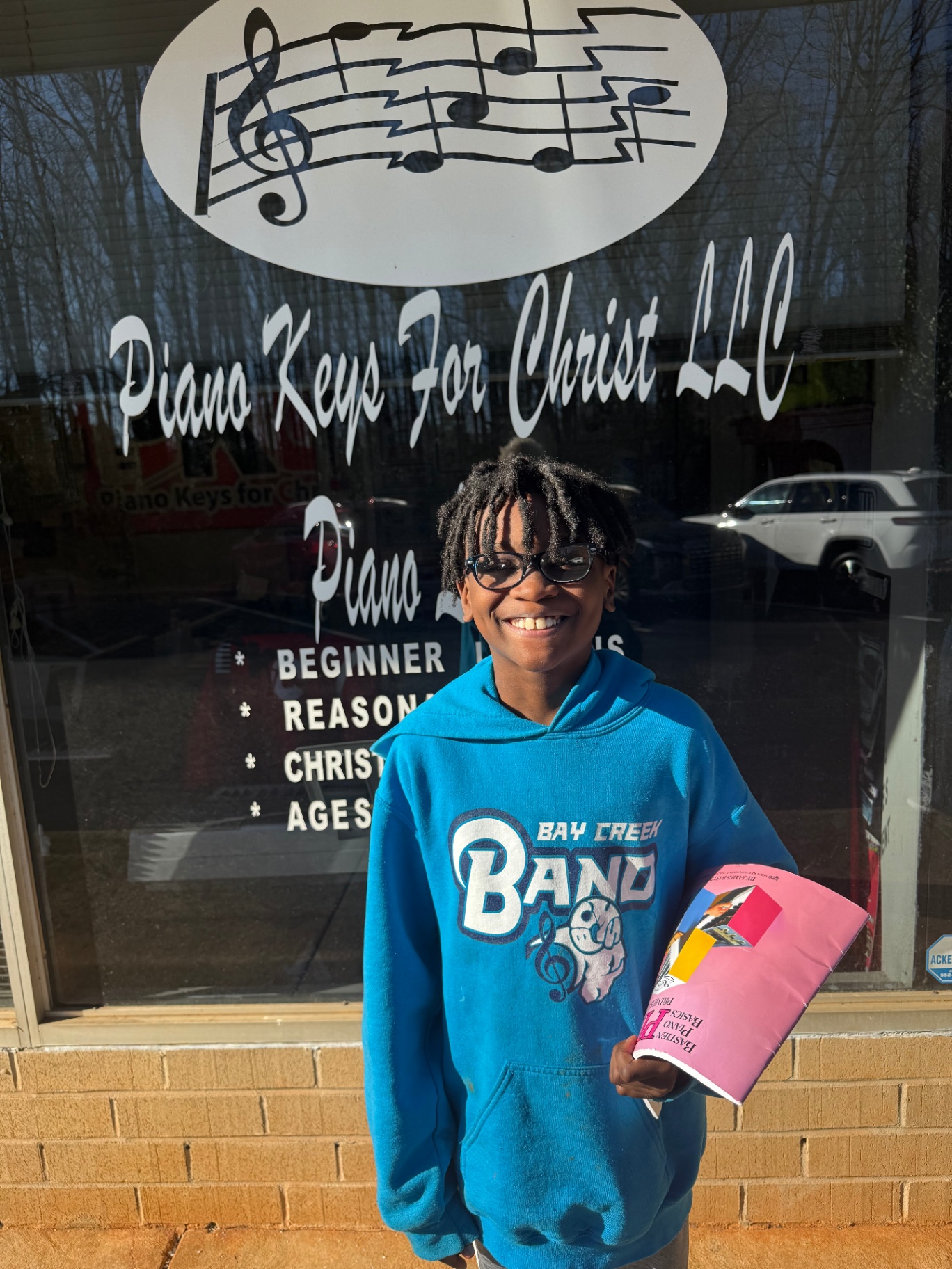 A smiling student at the PKC storefront