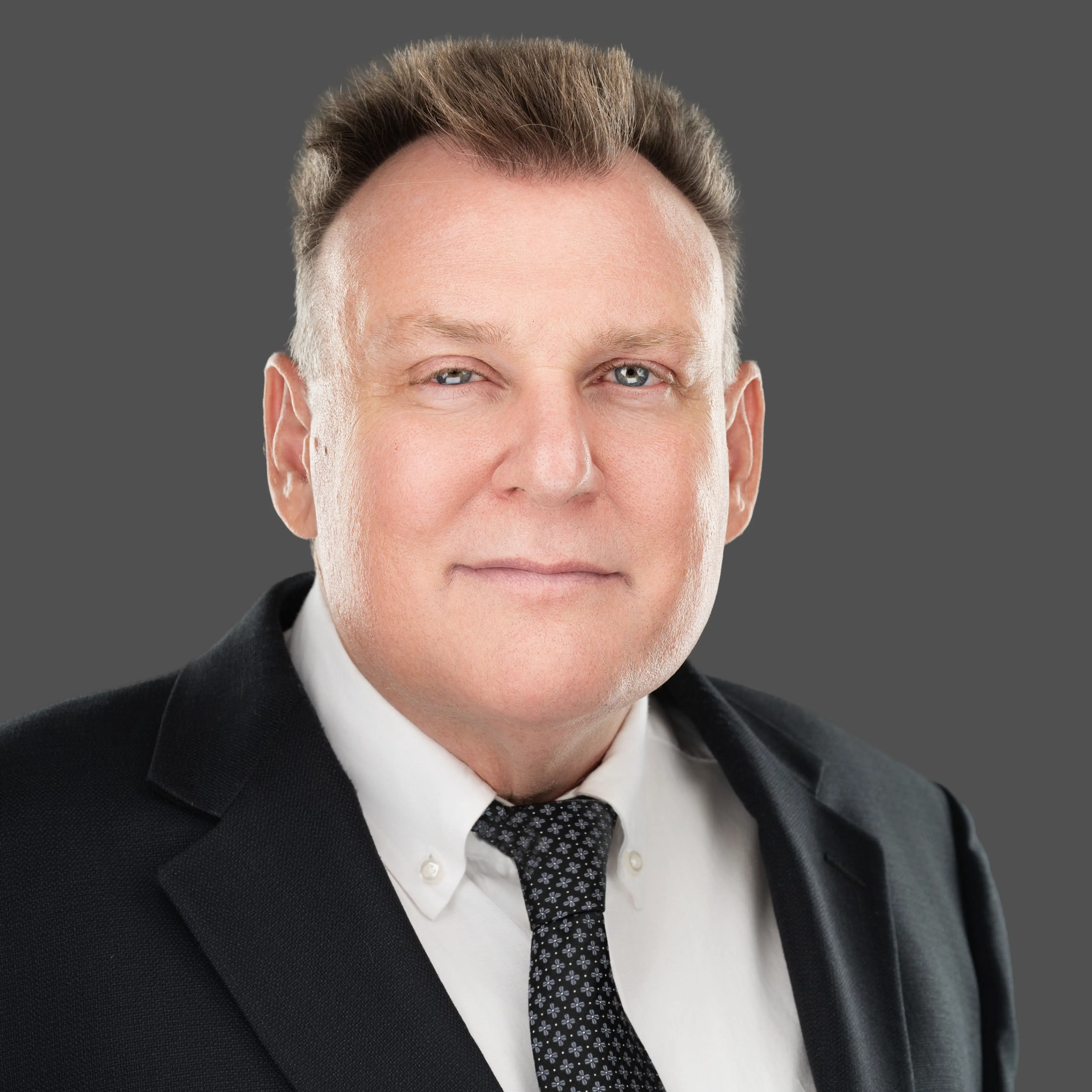 Professional headshot of a middle-aged man in a business suit representing the trustworthy experts at ProTaxMasters.