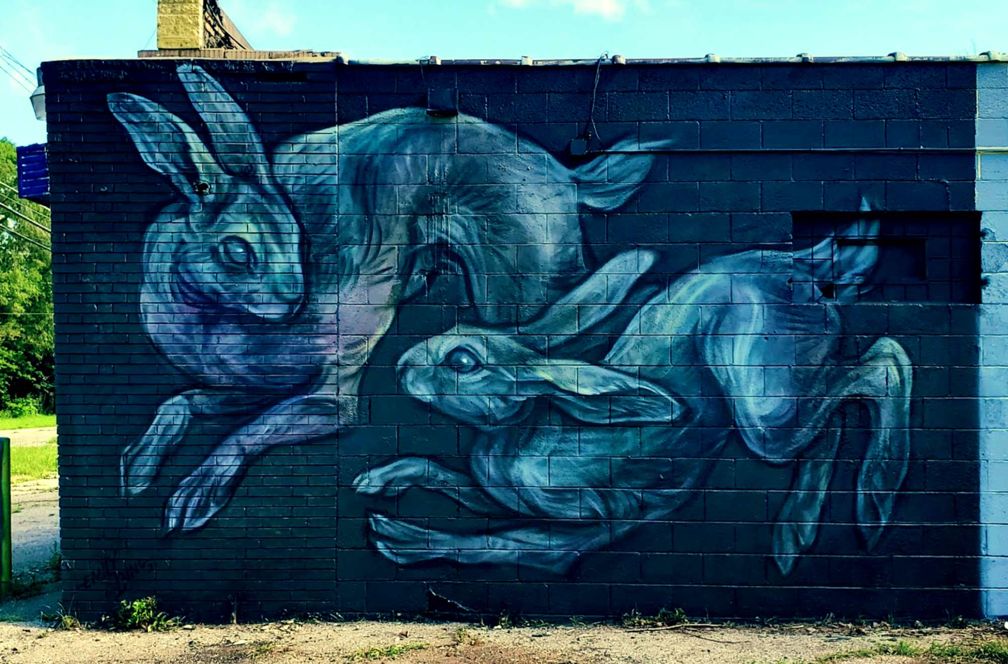 Community mural activation event with people engaging with public art