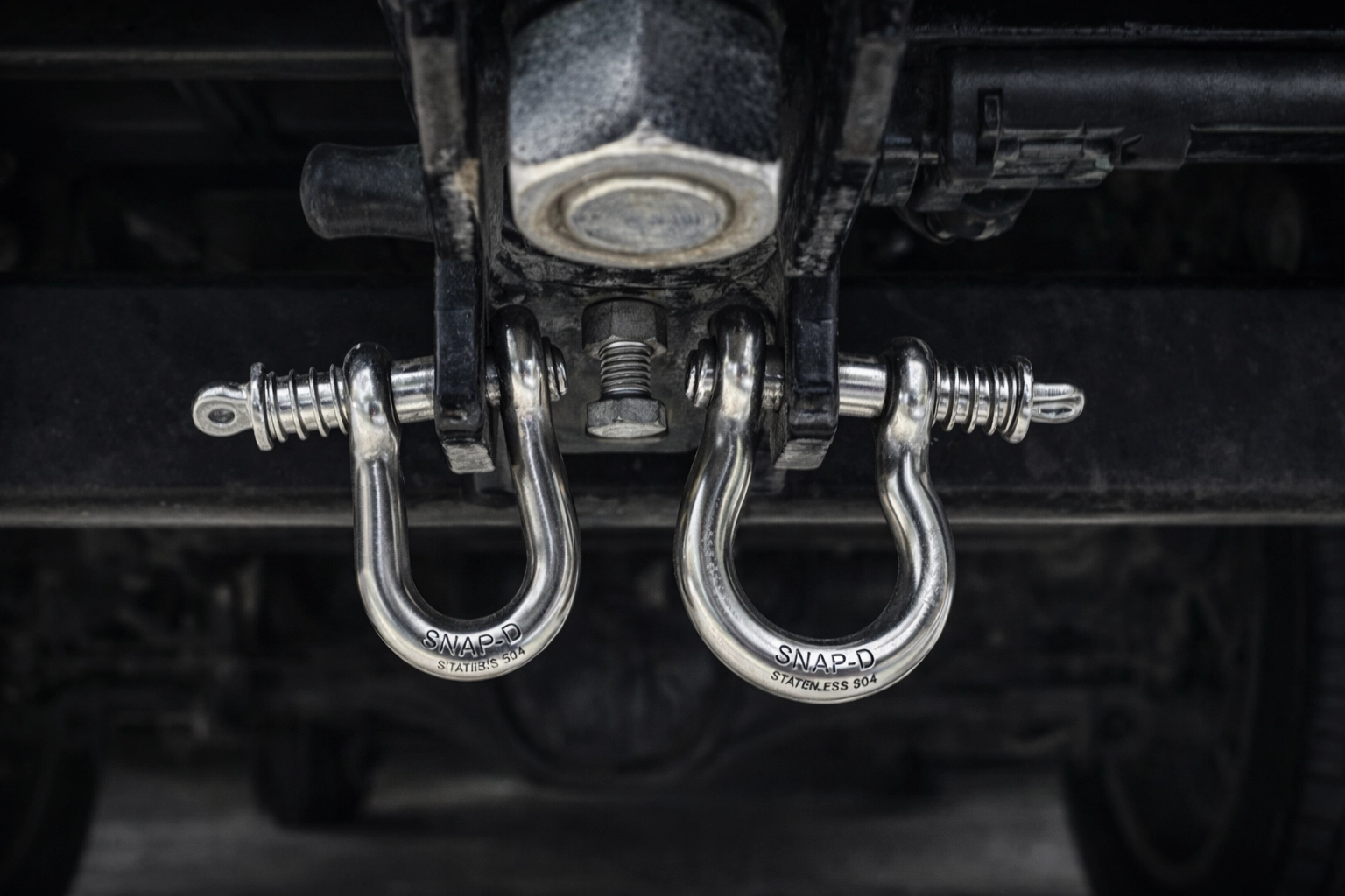 Snap-D 304 stainless half-turn shackle connecting safety chain to trailer attachment point