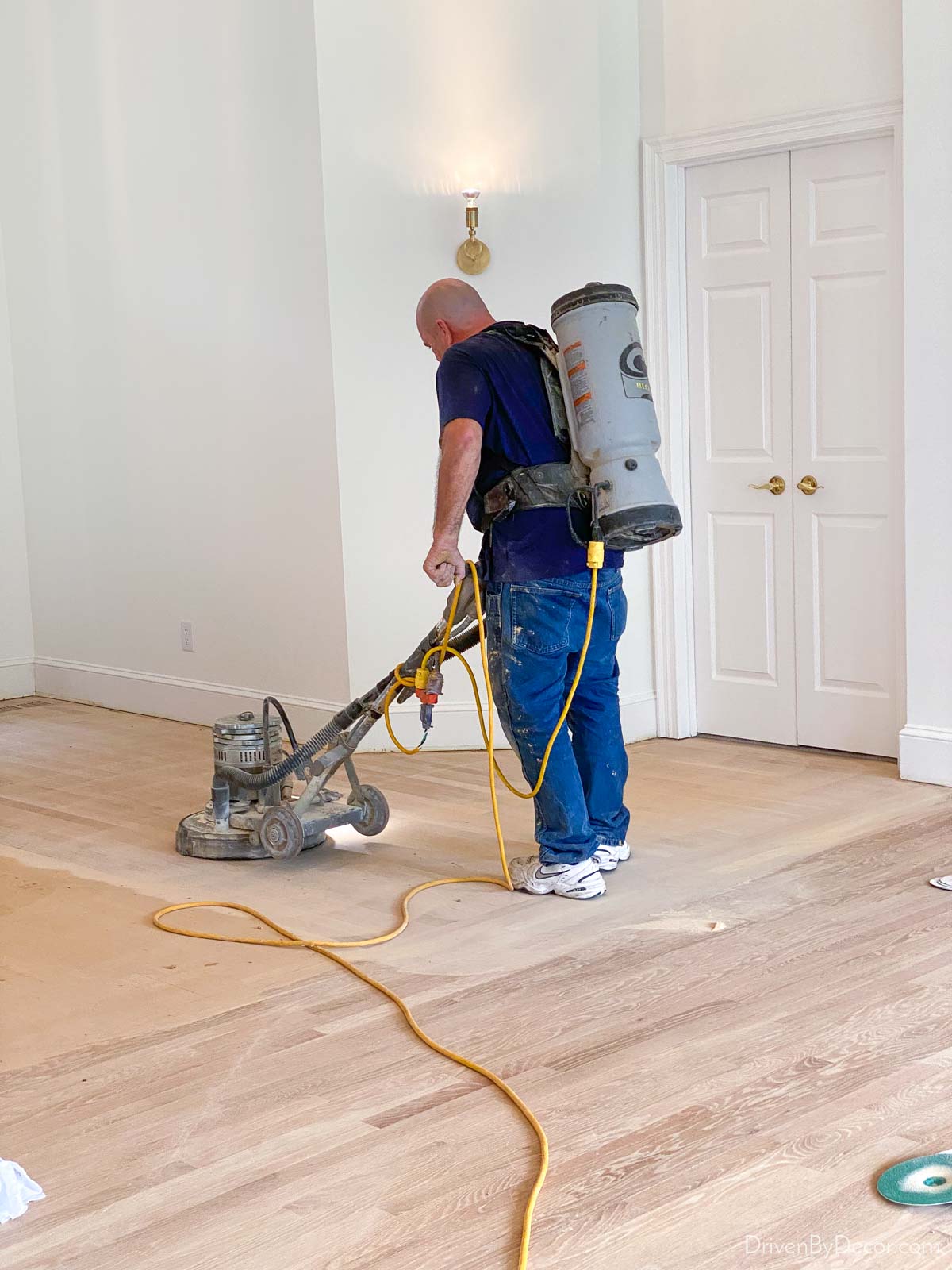 A specialist using advanced sanding equipment to refinish hardwood floors