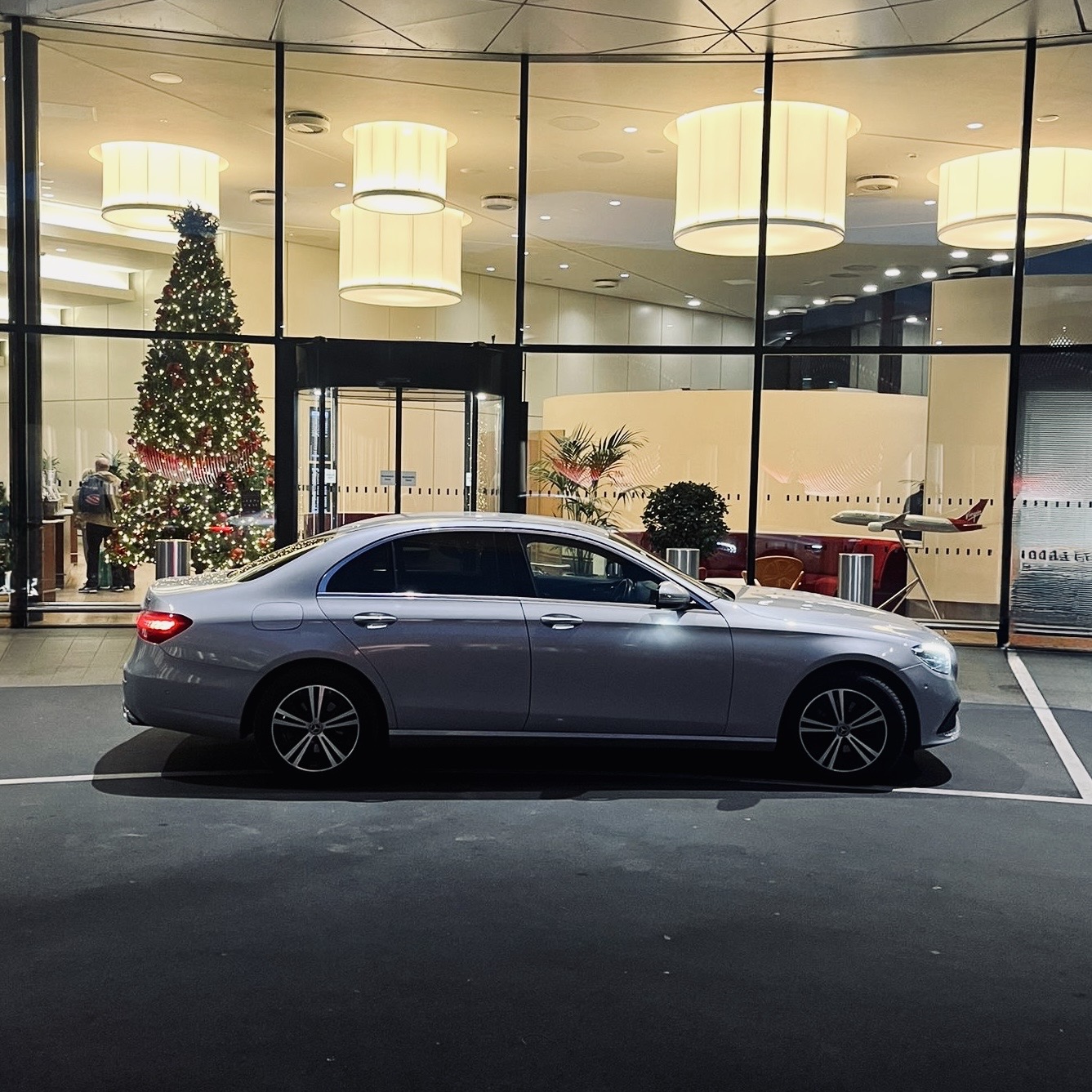 Silver Mercedes-Benz executive vehicle prepared for airport transfer