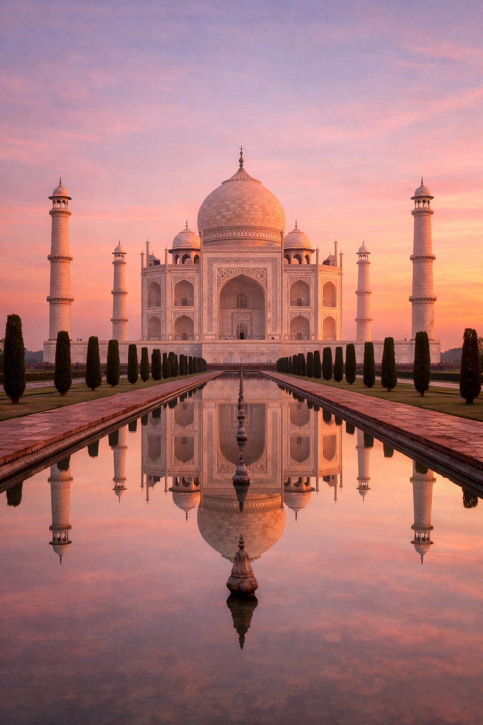 20 Most Iconic Places to Visit Around the World 3 The Taj Mahal at sunrise reflecting in the pool, one of the most instagrammable places in India.