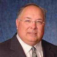 A professional man in a suit representing Tolmen Financial’s mission to guide clients.