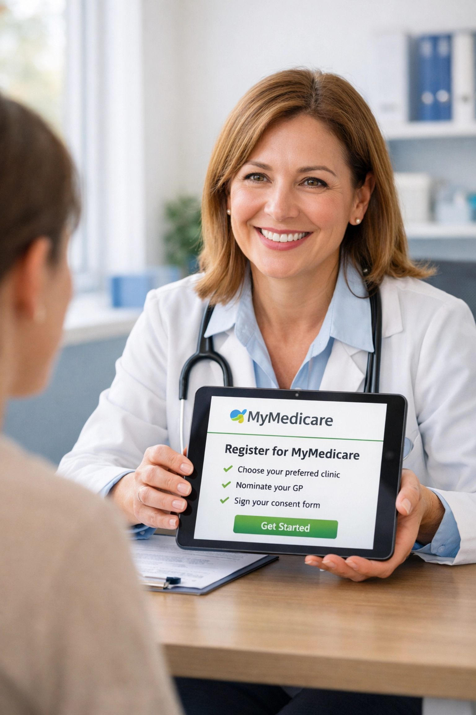 GP showing patient MyMedicare registration on tablet at clinic desk