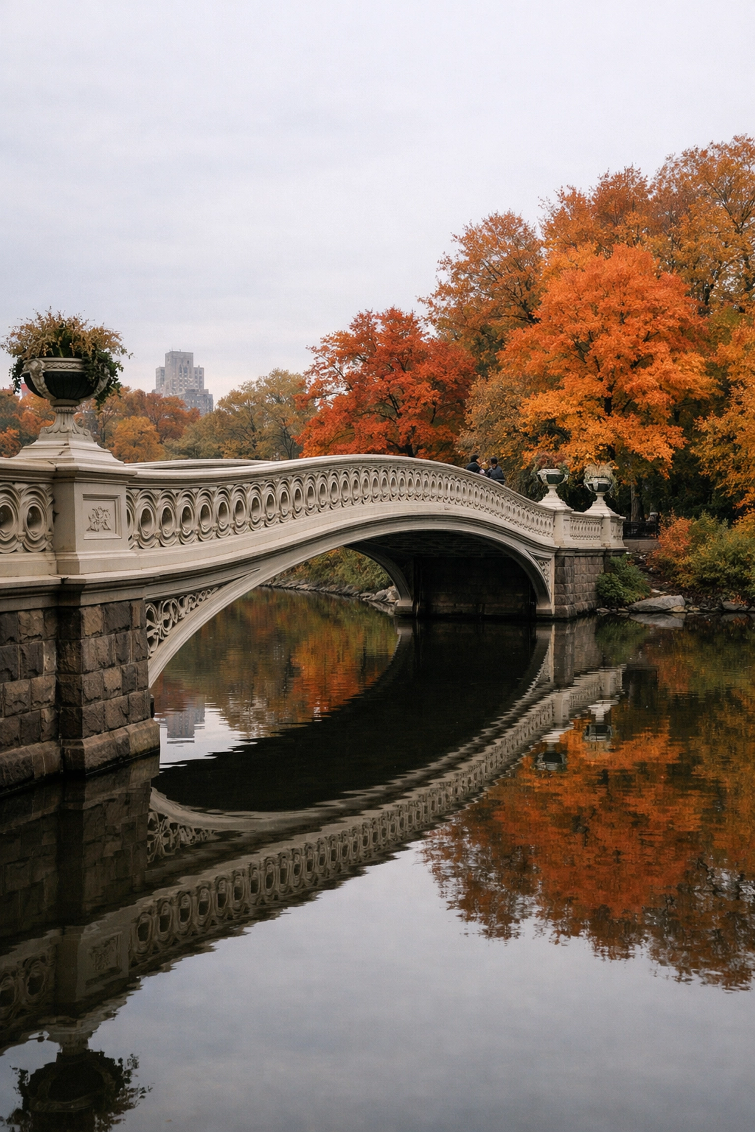 Bow Bridge in Central Park during autumn, one of the best places to take pictures in NYC with stunning reflections.