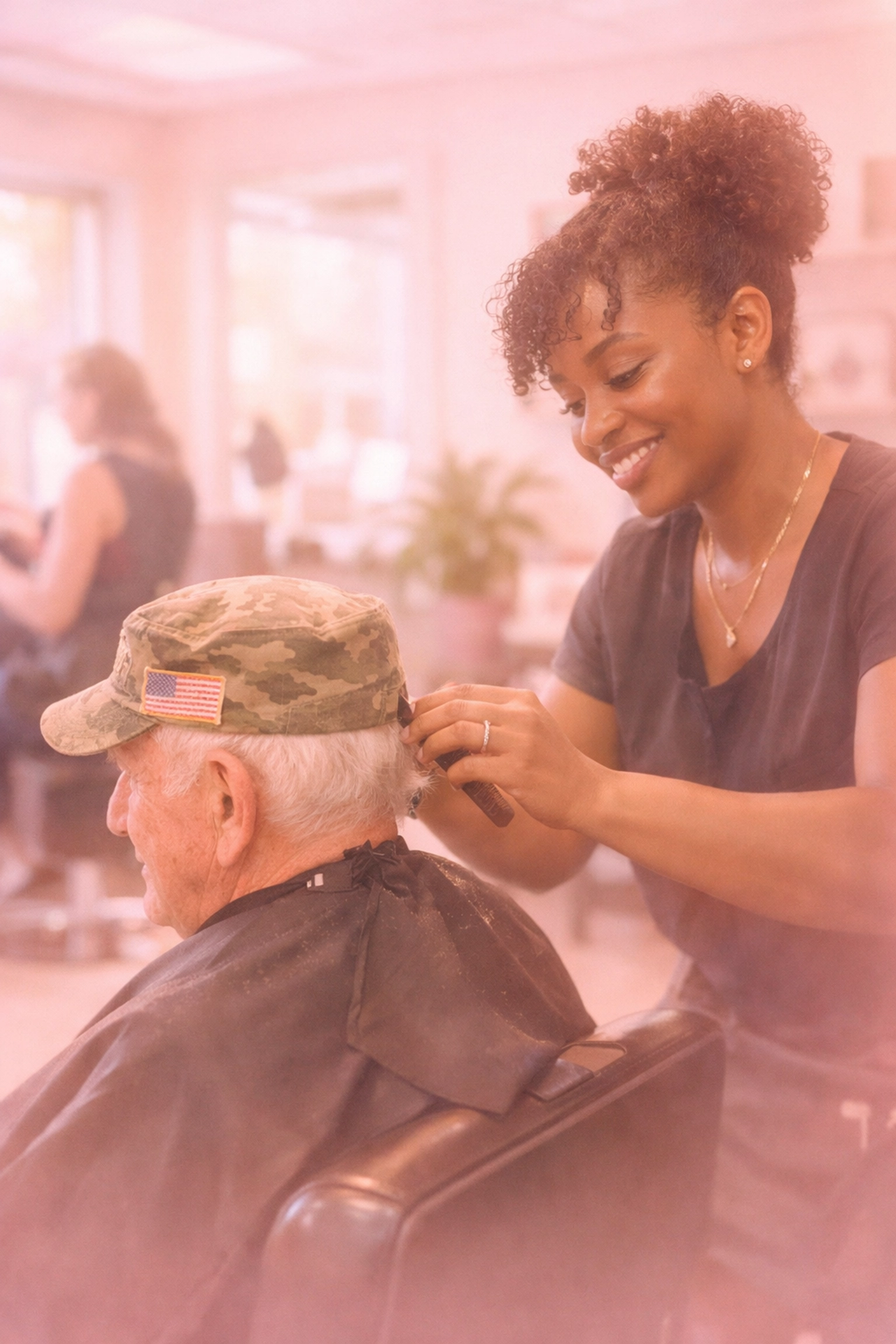 Black stylist providing salon therapy to elderly veteran in welcoming community space