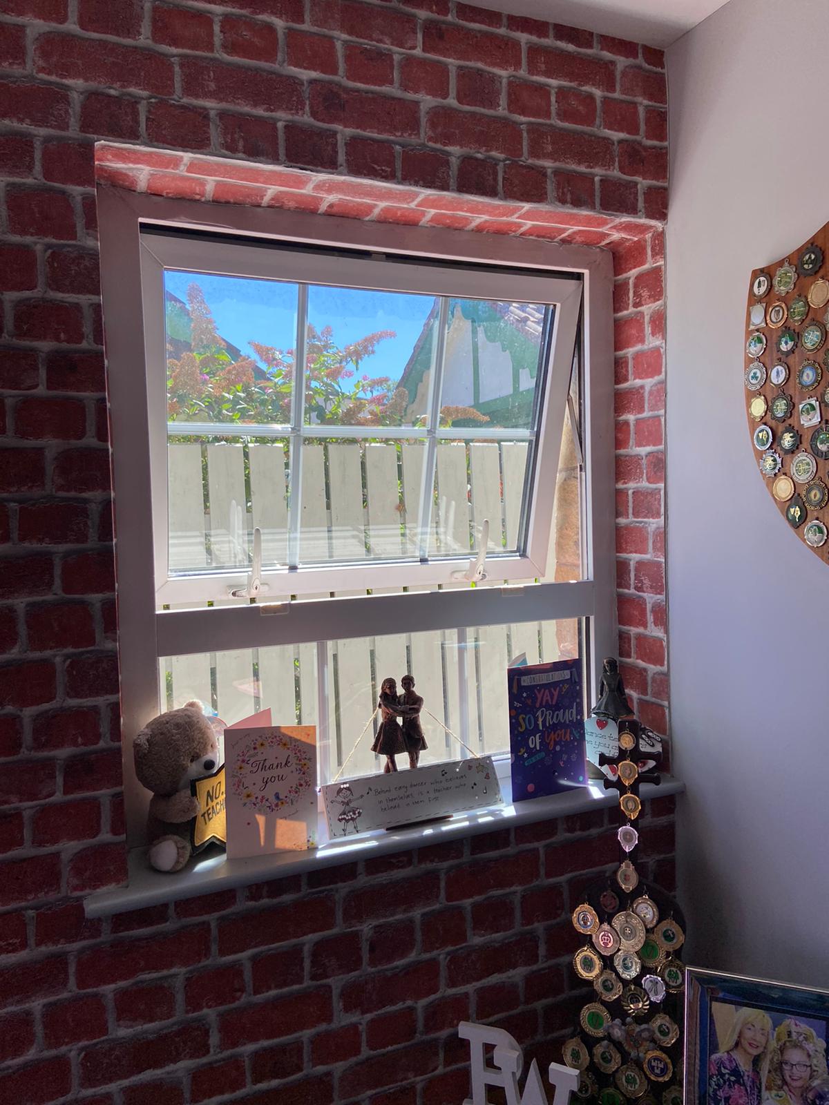 A double-glazed tilt-and-turn window with custom Fiesta Venetian blinds