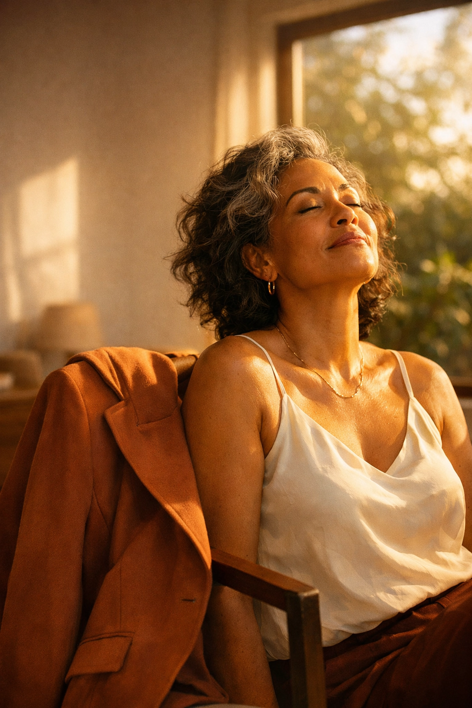 A mid-life woman relaxing in a sunlit room, symbolizing relief from the Superwoman mental health burden.