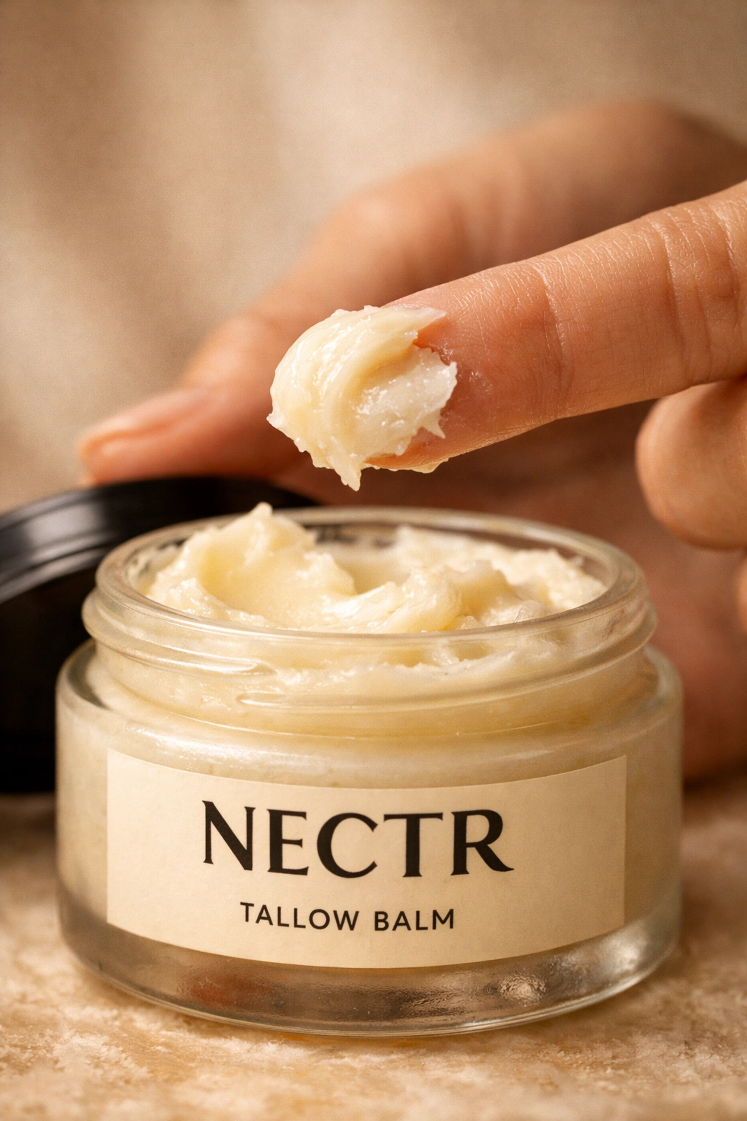 Close-up of the rich, buttery texture of NECTR tallow balm, a natural barrier cream for healthy skin.