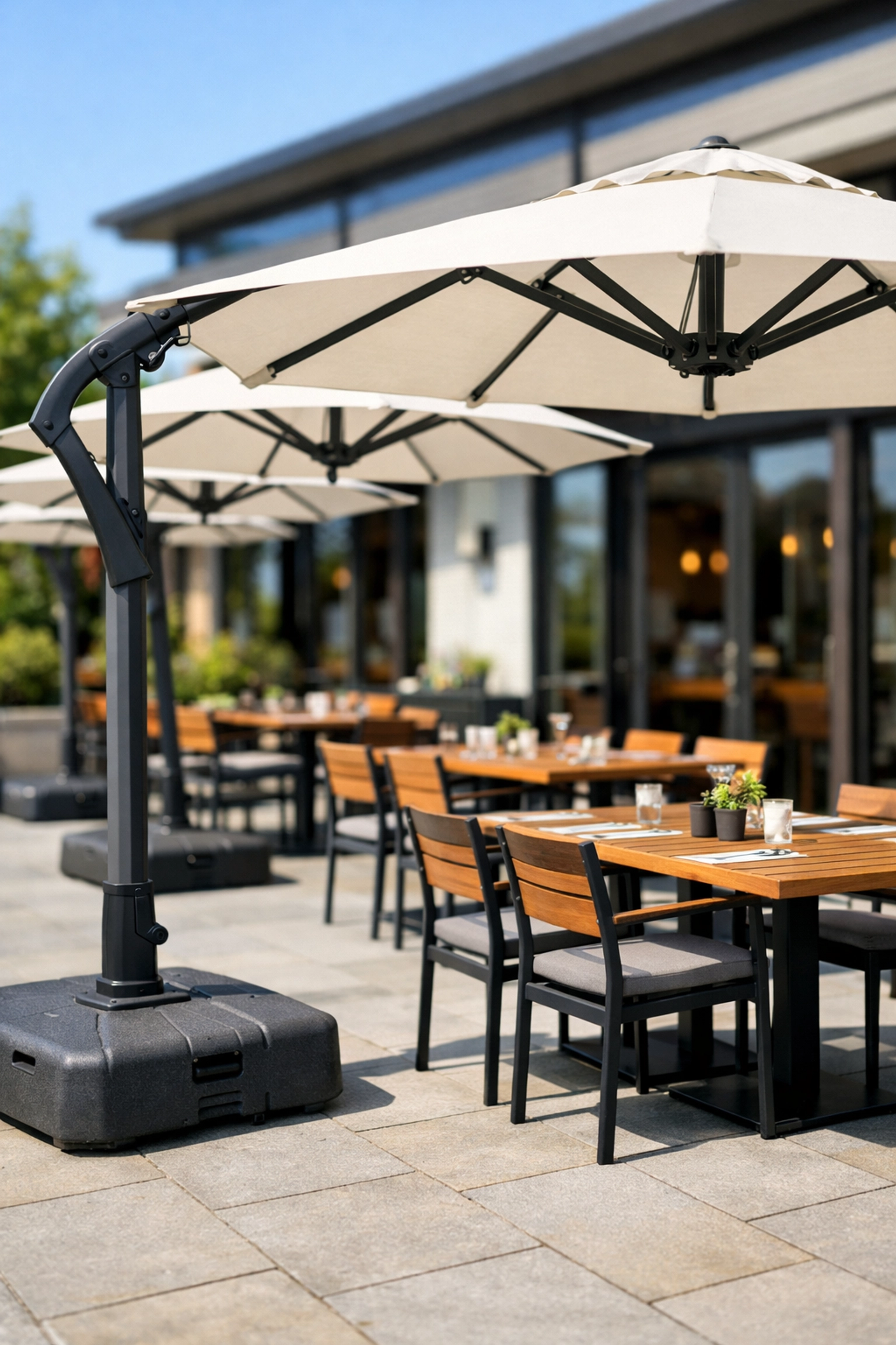 Secure patio umbrellas and stable tables at a modern restaurant to prevent summer guest accidents.