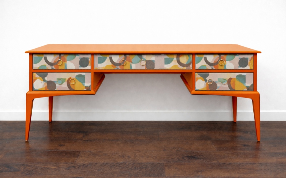 Vibrant orange abstract Stag-style desk/dressing table with bold modern pattern.