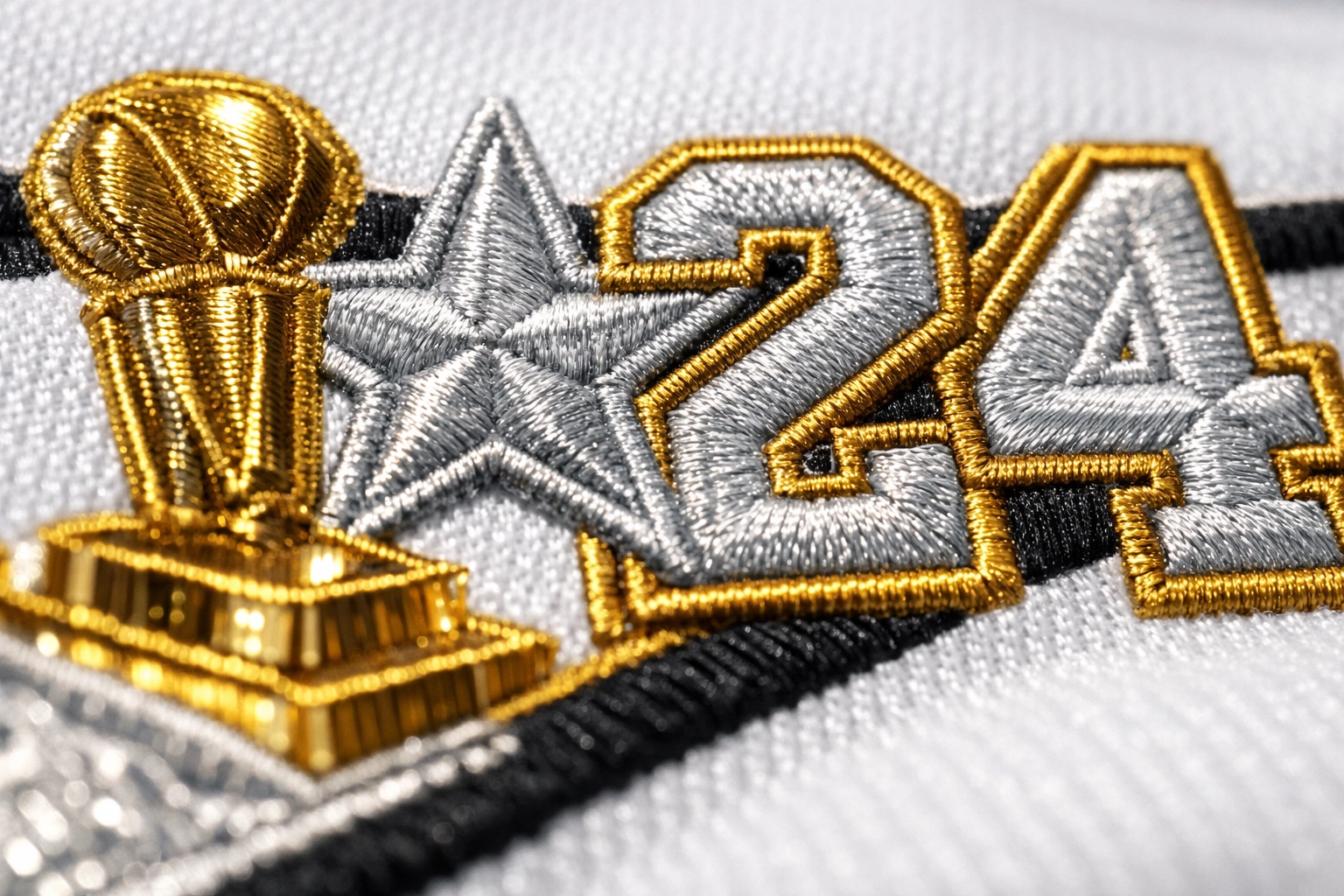 Intricate gold and silver embroidery detailing career stats and trophies on a limited edition jersey.