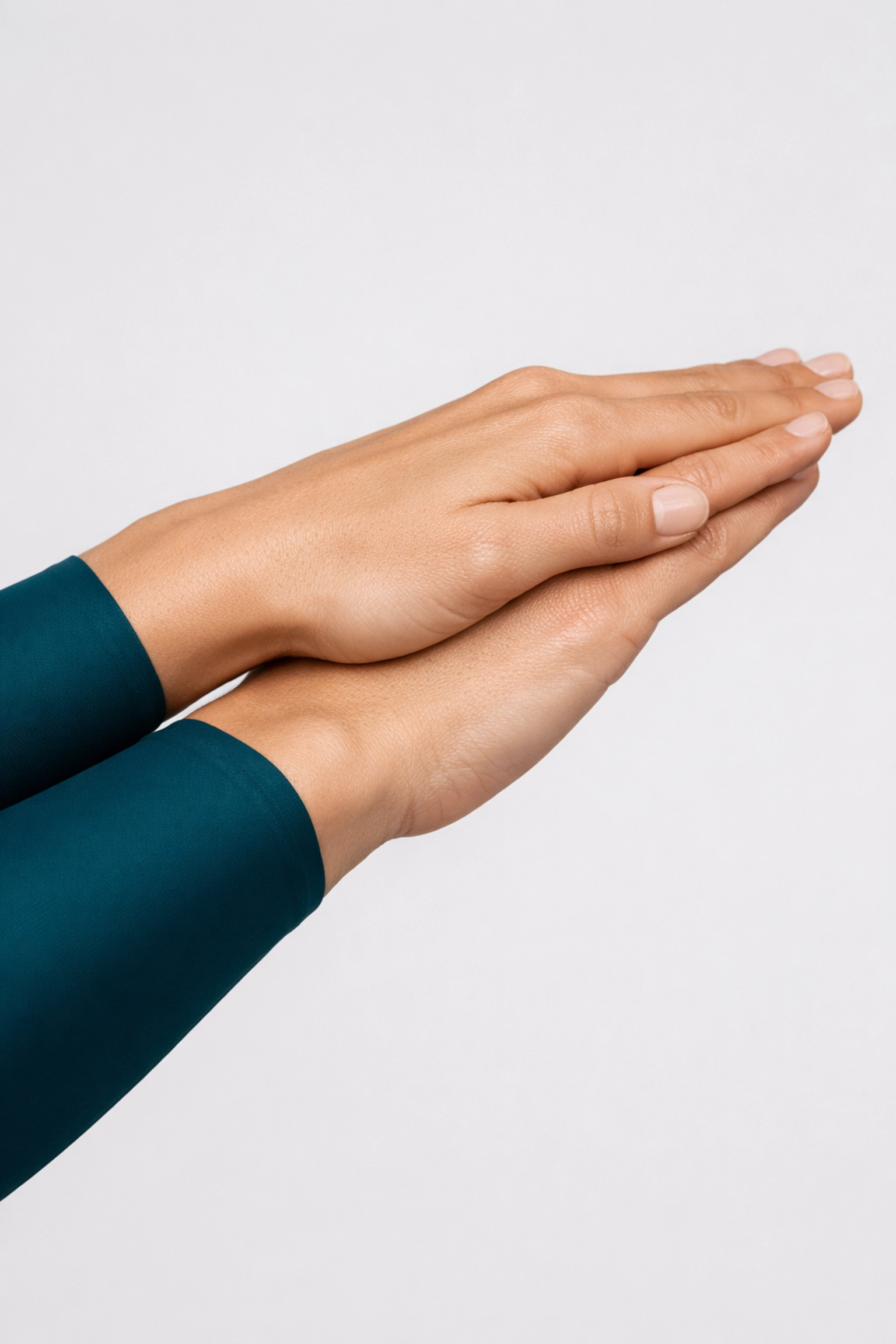 Close-up of locked hands in a streamlined swimming position to minimize drag and improve speed.