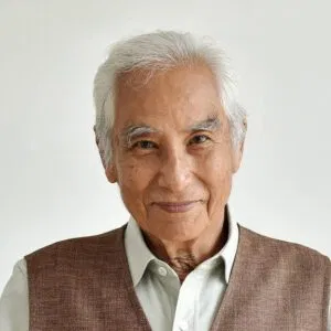 A confident senior business owner with silver hair, representing a client preparing for retirement.