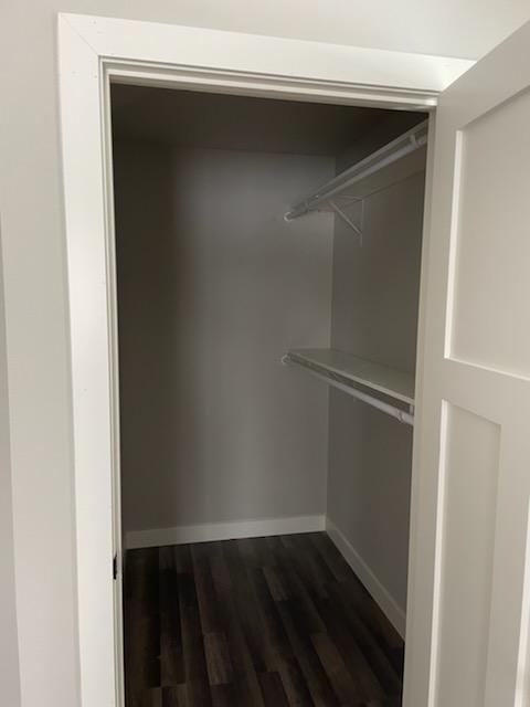 Walk-in closet with white shelving in a Dancing Sky duplex in Spearfish