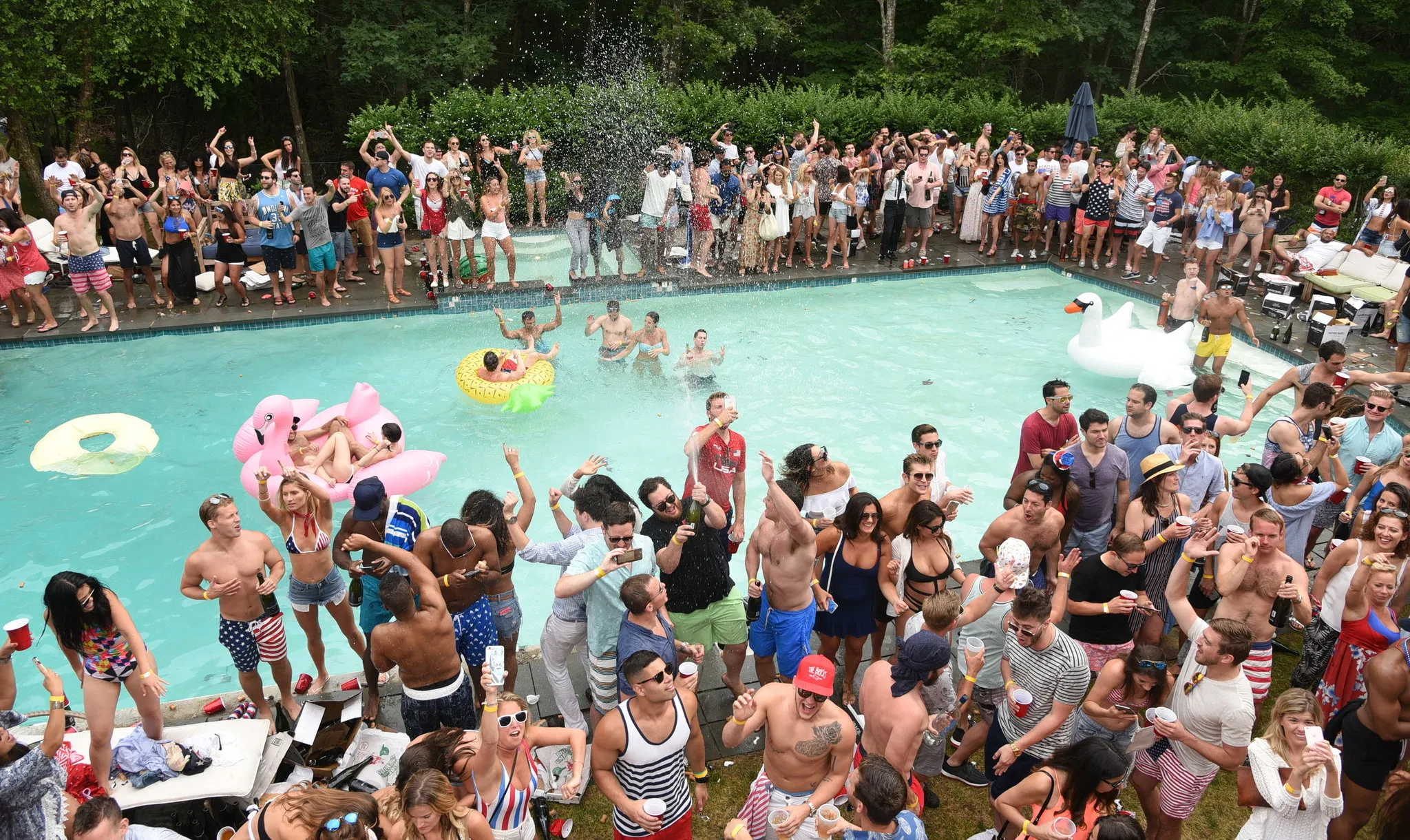 911 medellin security pool party Large outdoor pool party featuring a dense crowd