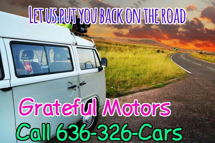 A white van travels down an open road at sunset with Grateful Motors contact info