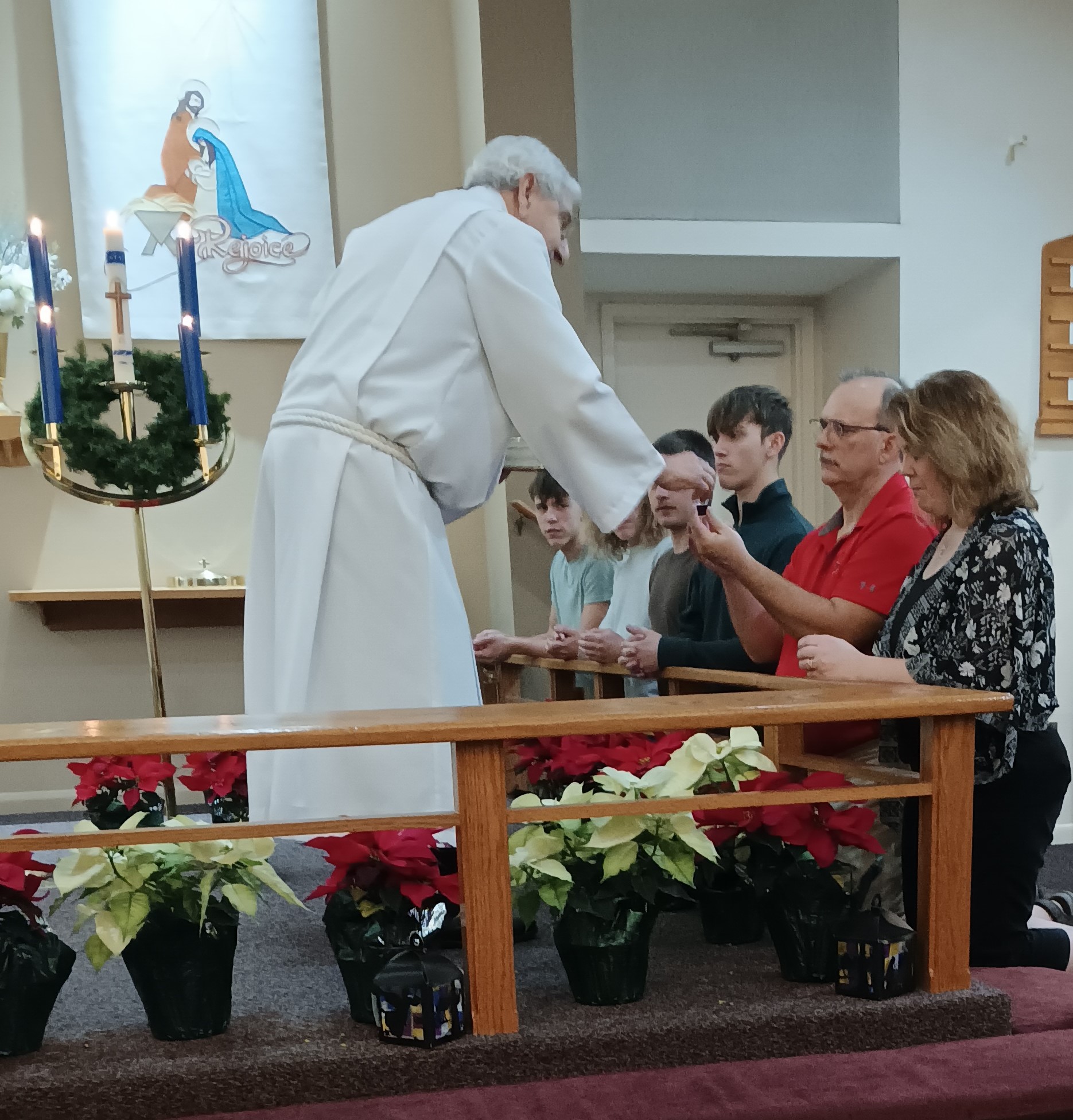 A pastor distributing Holy Communion in a Lutheran worship setting