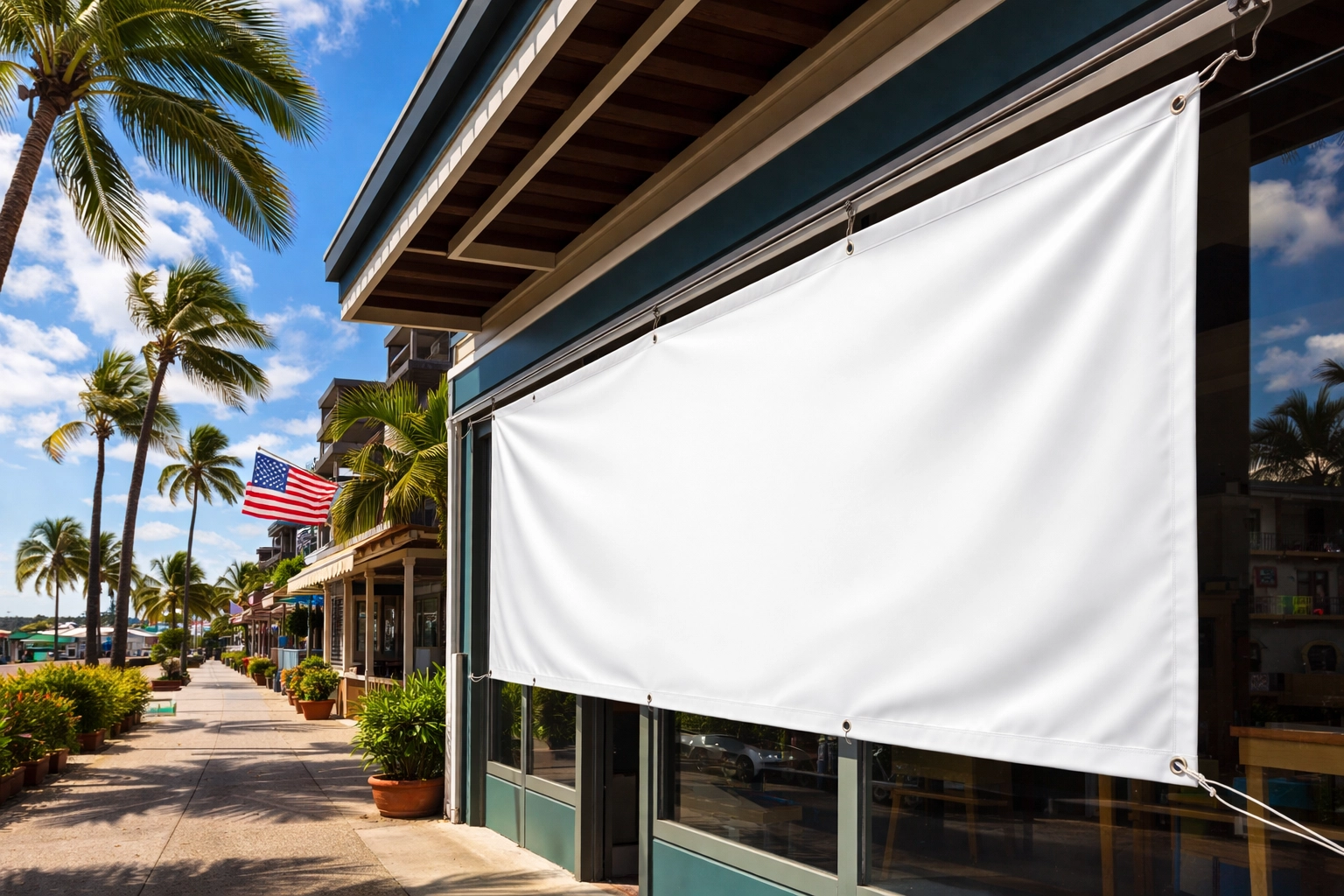Professional outdoor banner securely mounted on a Kona storefront with reinforced grommets