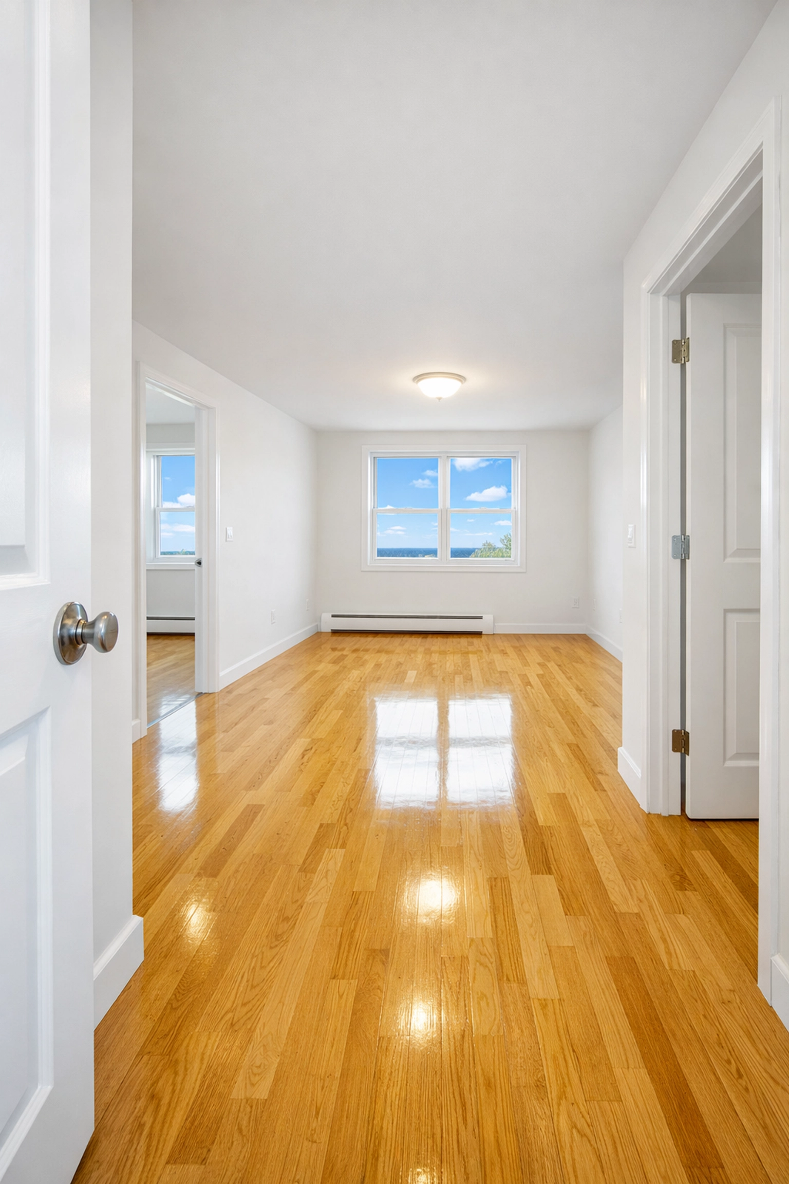 Pristine hardwood floors in an apartment after a professional cleaning for a move-out.
