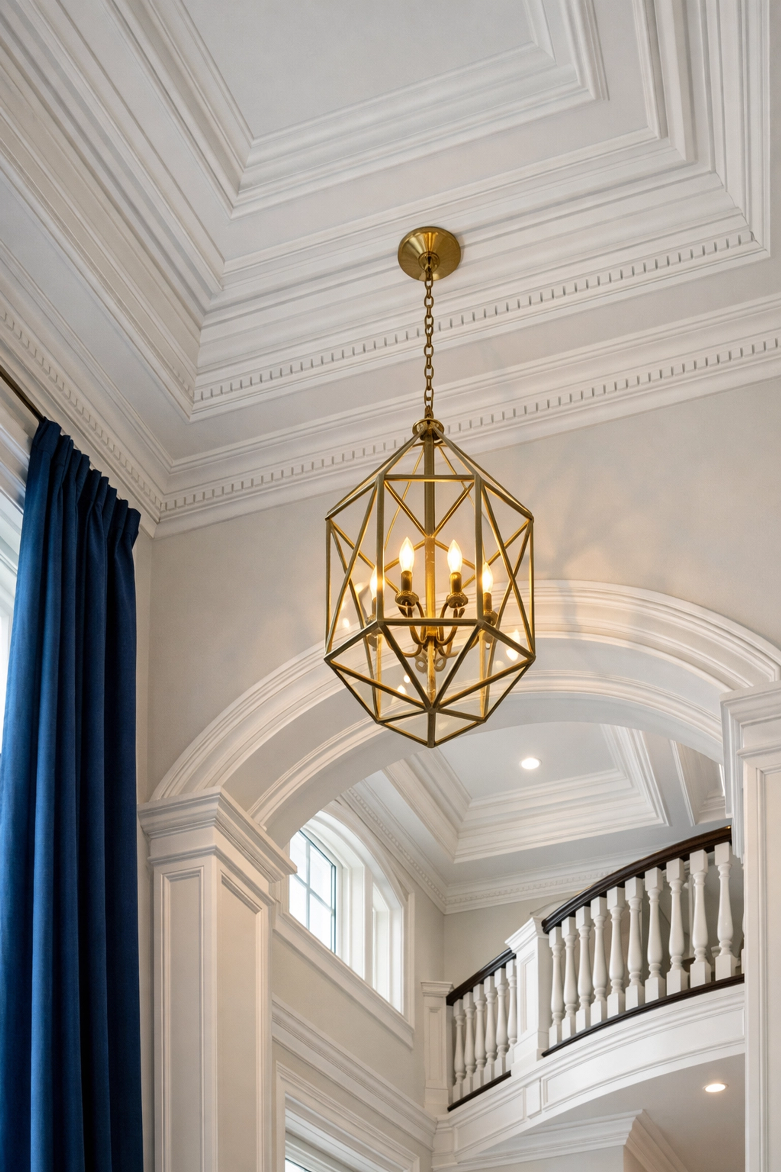 Detailed post-construction cleaning of luxury crown molding and fixtures in an Ashland home foyer.