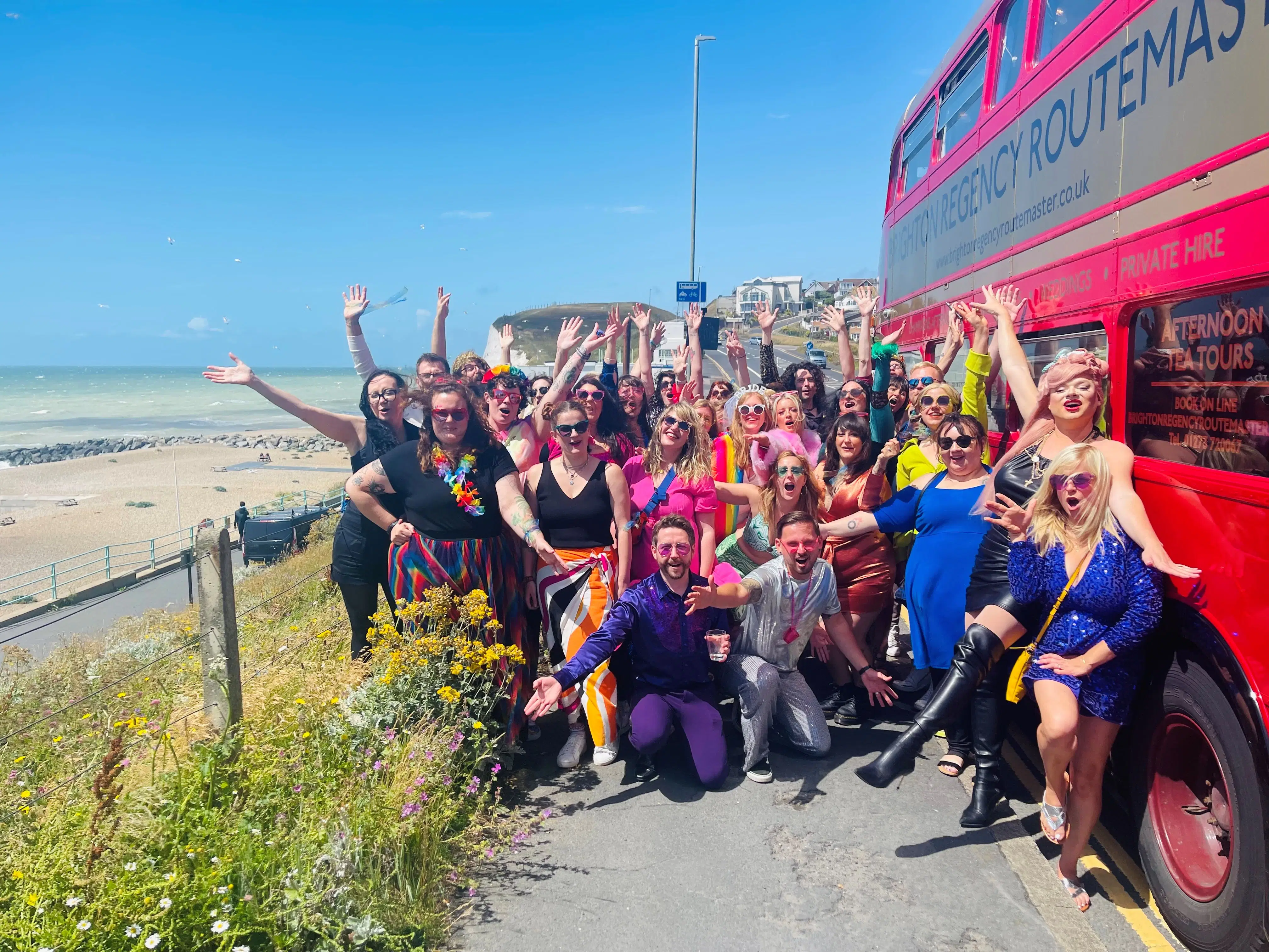 Drag queen on a fabulous closed top bus by the Royal Pavilion, a fun Brighton hen party activity.