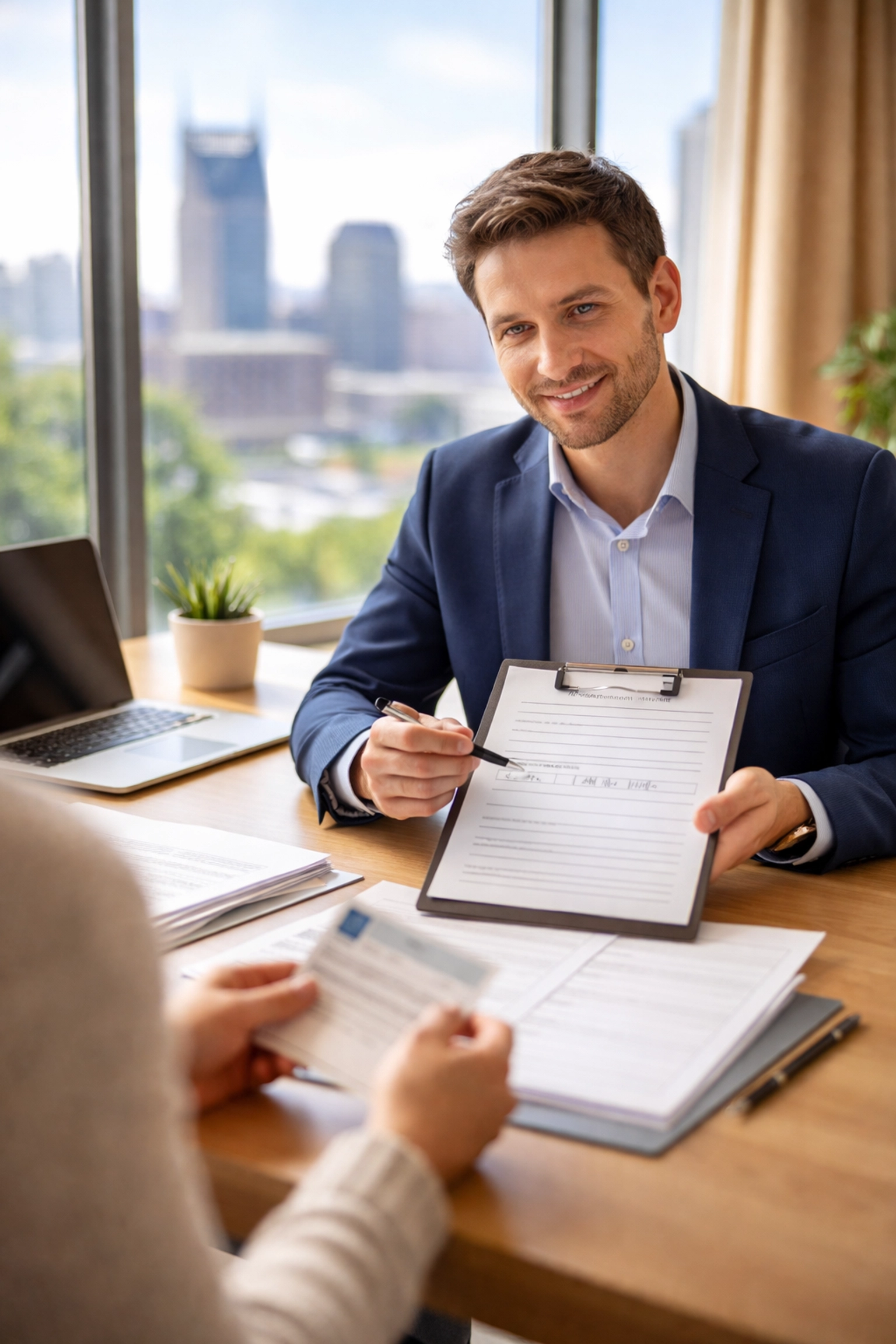 Property manager interviewing tenant in Nashville office, showcasing thorough tenant screening process
