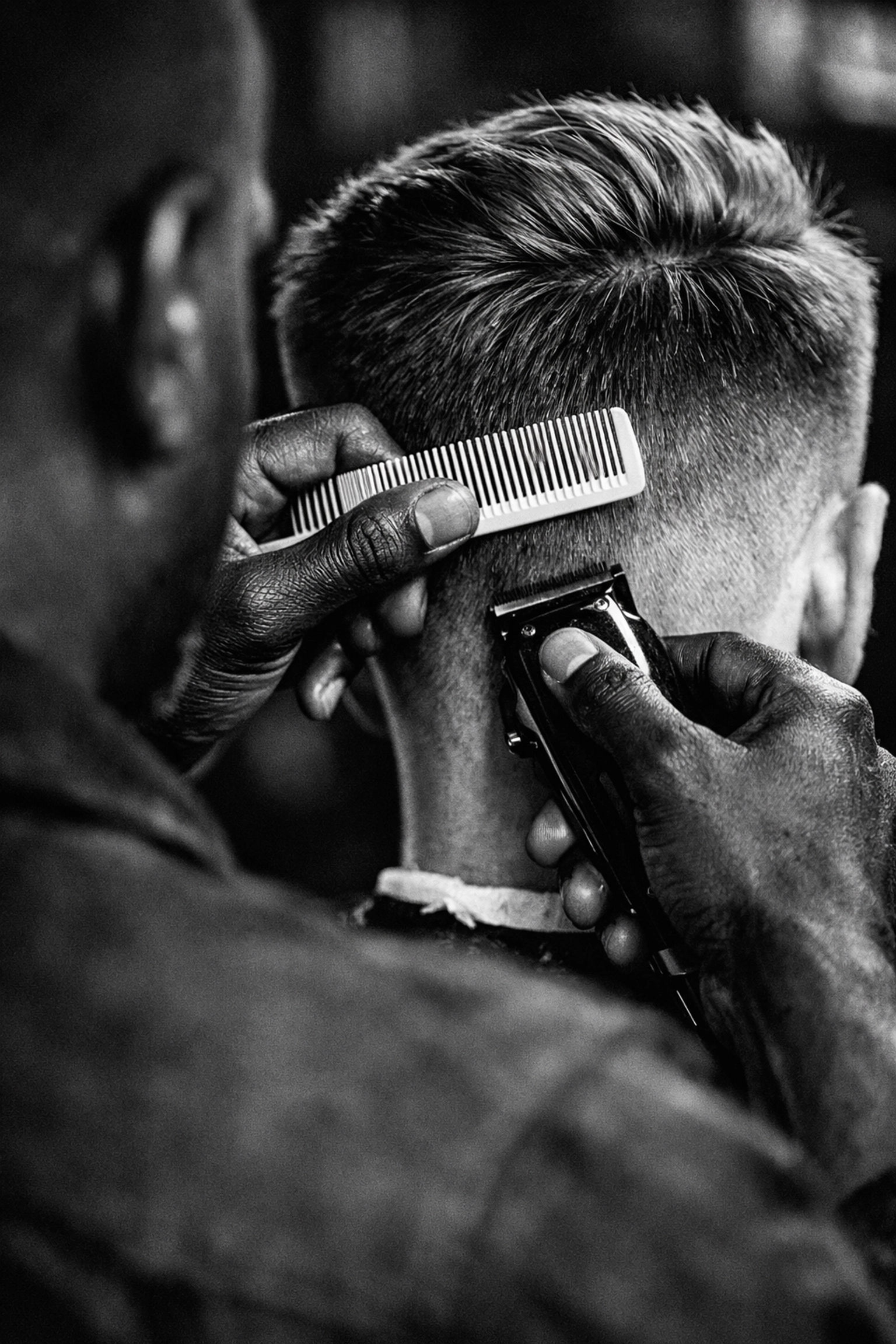 Barber instructor teaching a multicultural hair fading technique at the Middletown campus.