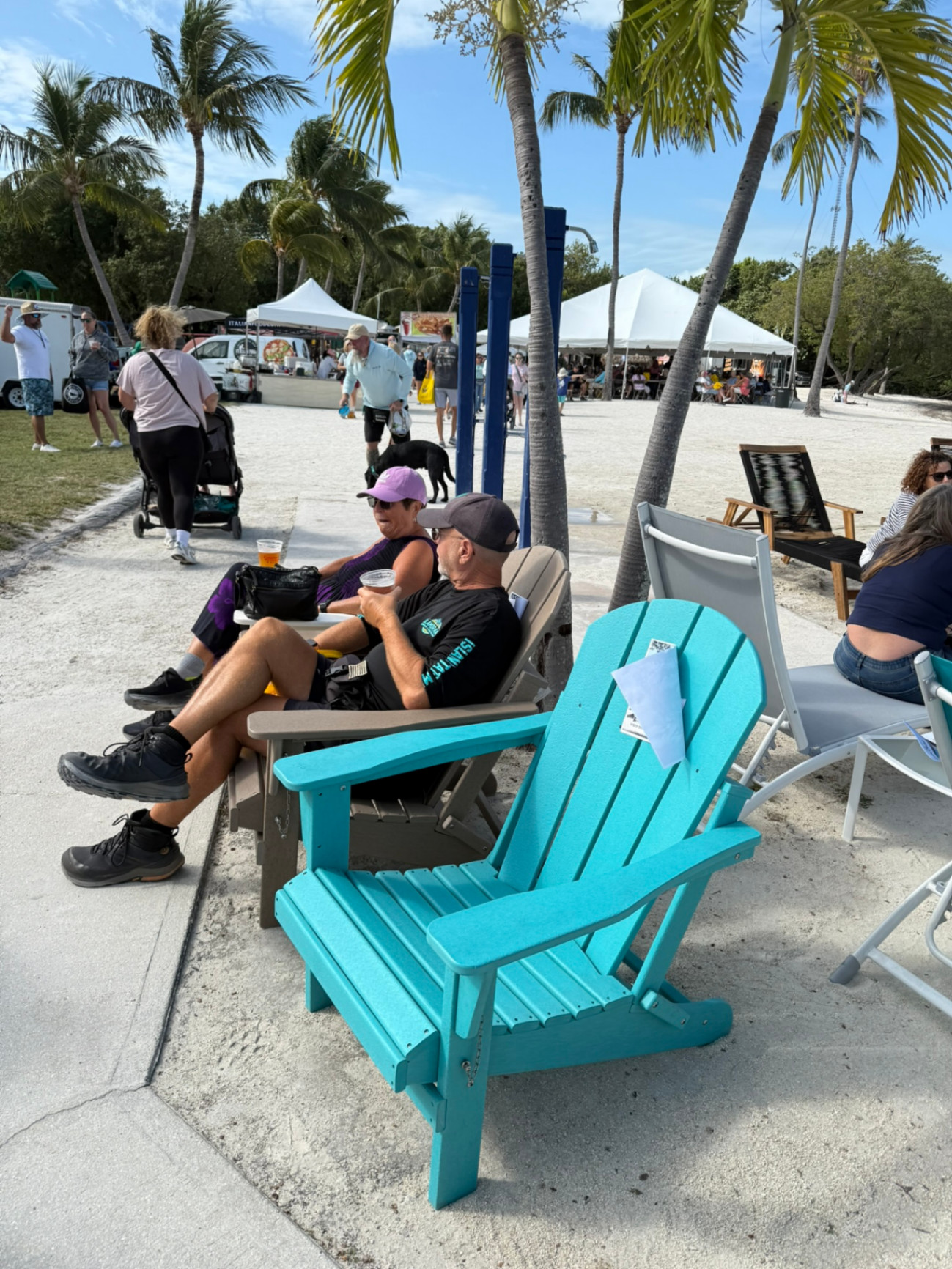 Iconic colorful Adirondack chairs set up on the sand—easygoing, beach-ready seating that fits the Florida Keys vibe and stands up to the elements