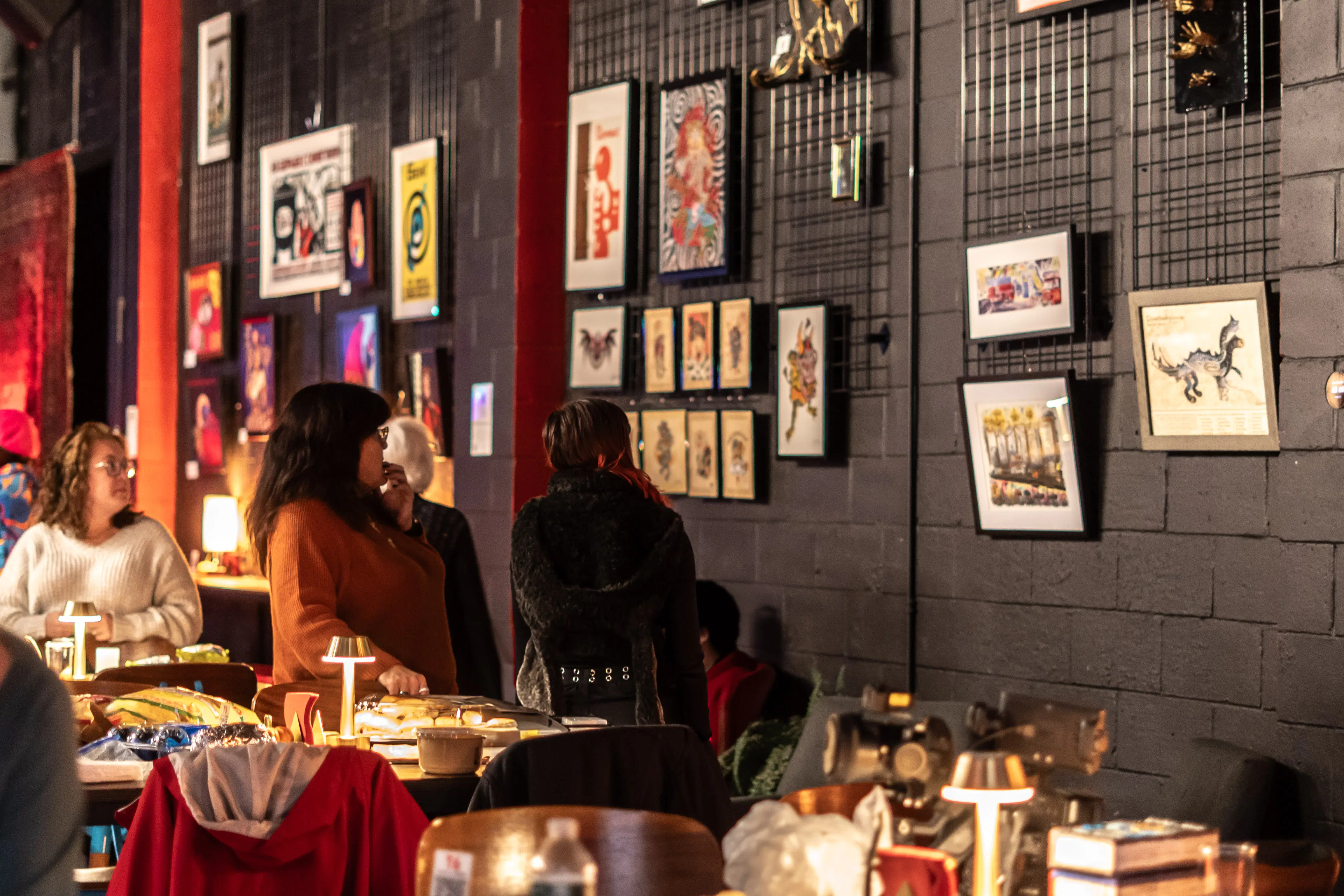 [PHOTO] Guests viewing artwork at an exhibition